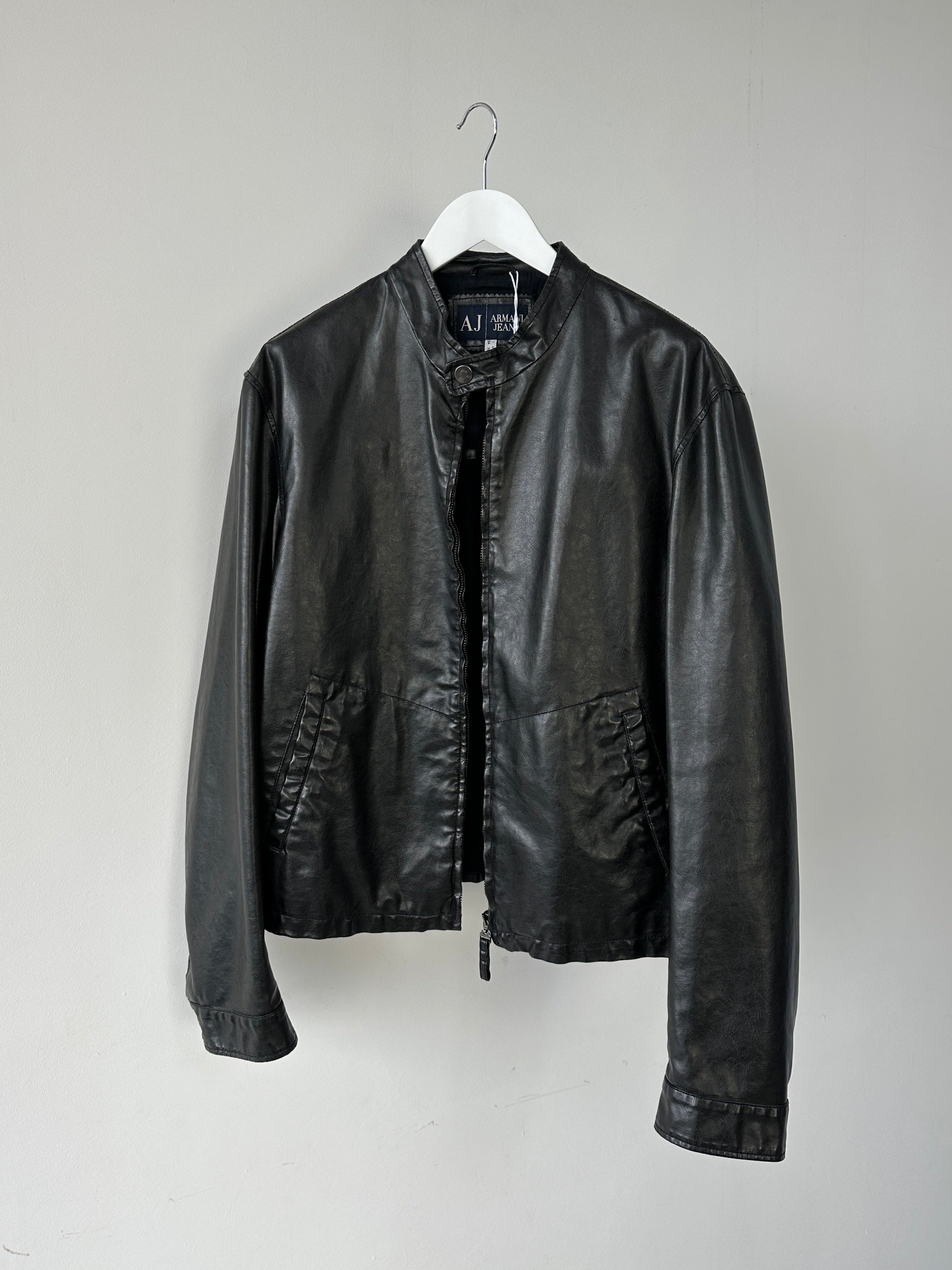 Armani Jeans faux leather biker jacket in size M, stylish black leather jacket with classic biker design and silver hardware.