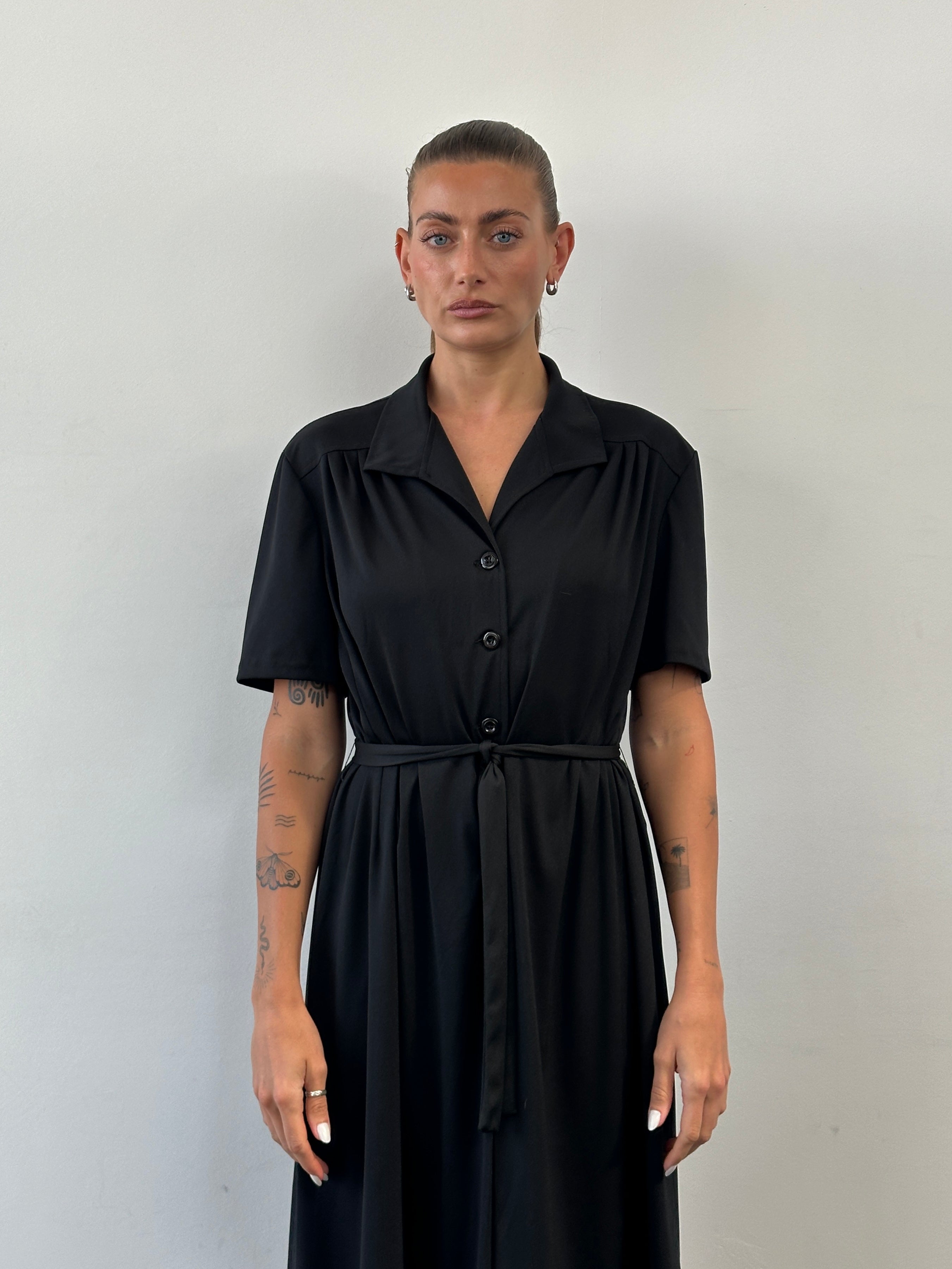 Vintage 1990s belted short sleeve midi shirt dress displayed on a hanger, showcasing its classic style and vintage fabric details.