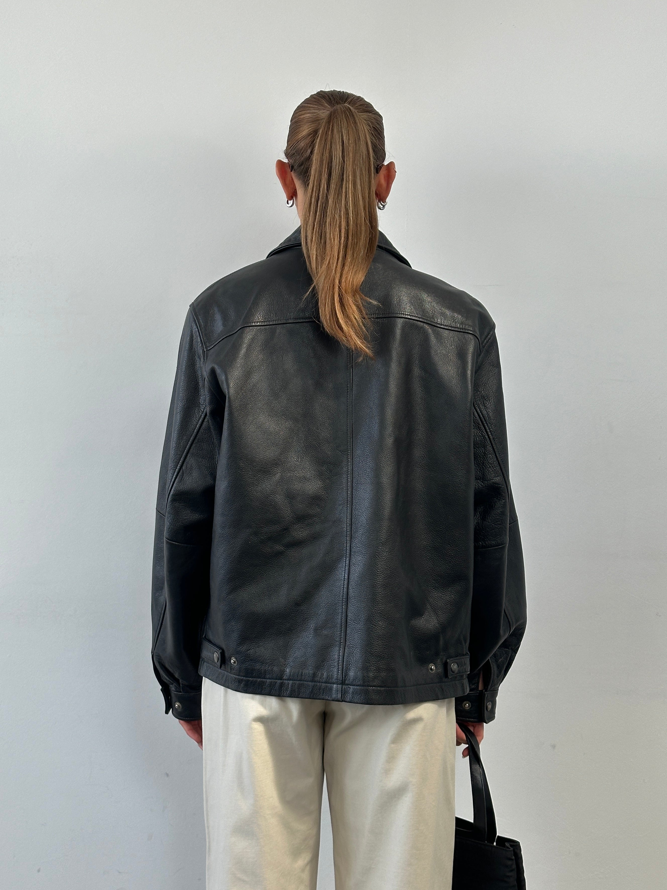 Vintage minimal leather jacket in size L, featuring a classic design with smooth leather and clean lines.