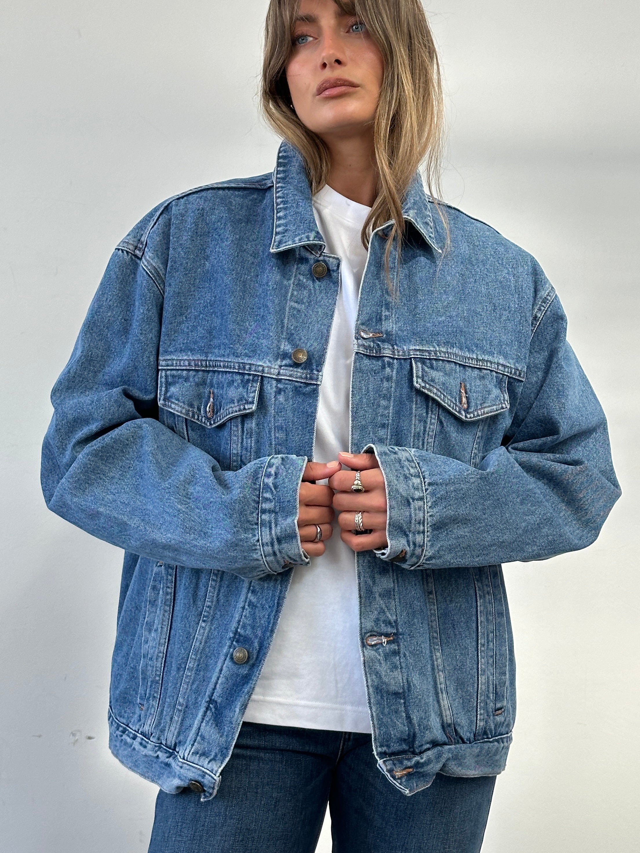 Vintage oversized pure cotton denim jacket in XL, showing classic blue denim fabric and button-front design.