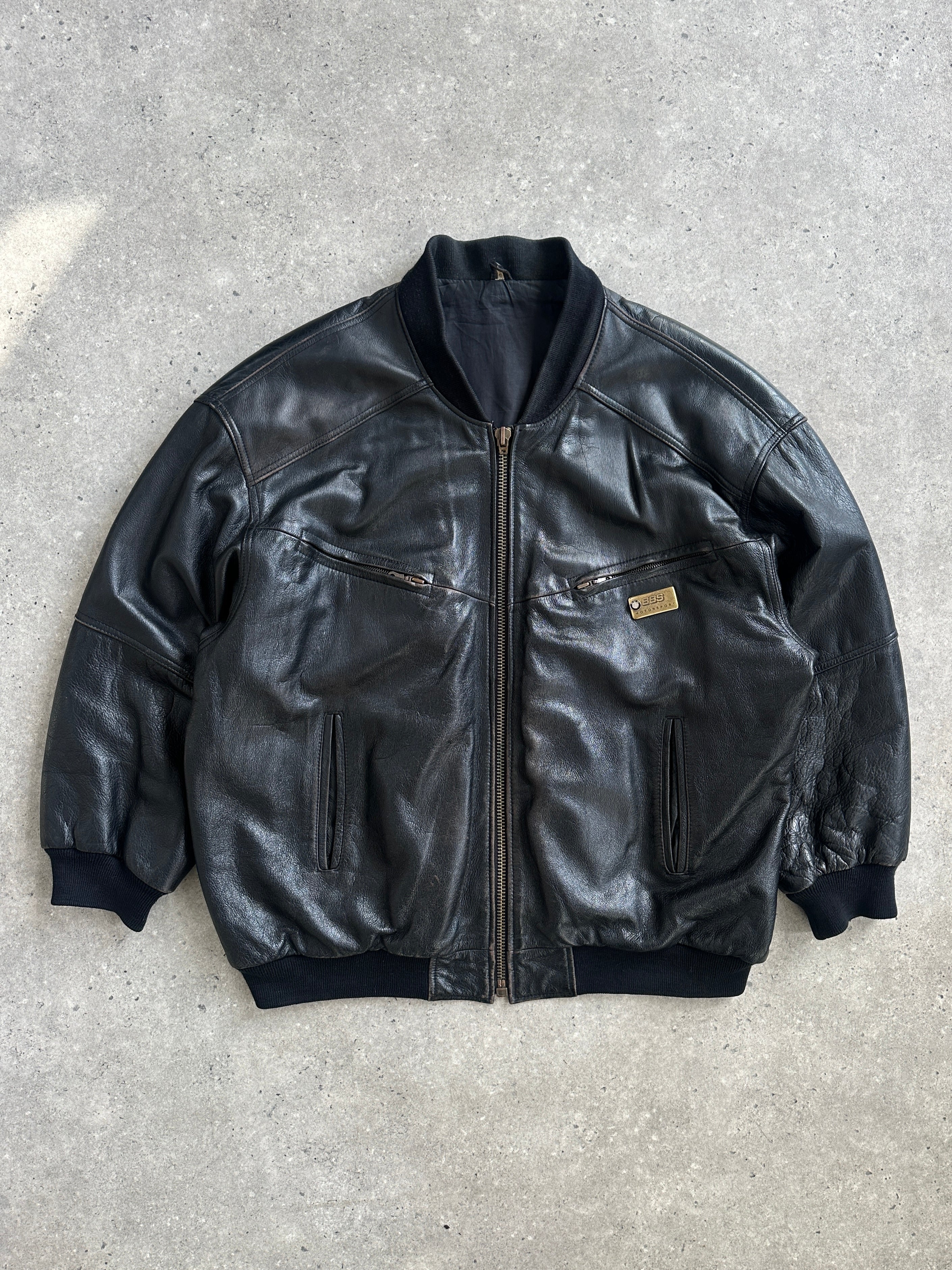 Vintage BMW 1990s leather bomber jacket, XL size, showing classic design, brown leather with ribbed cuffs and collar.