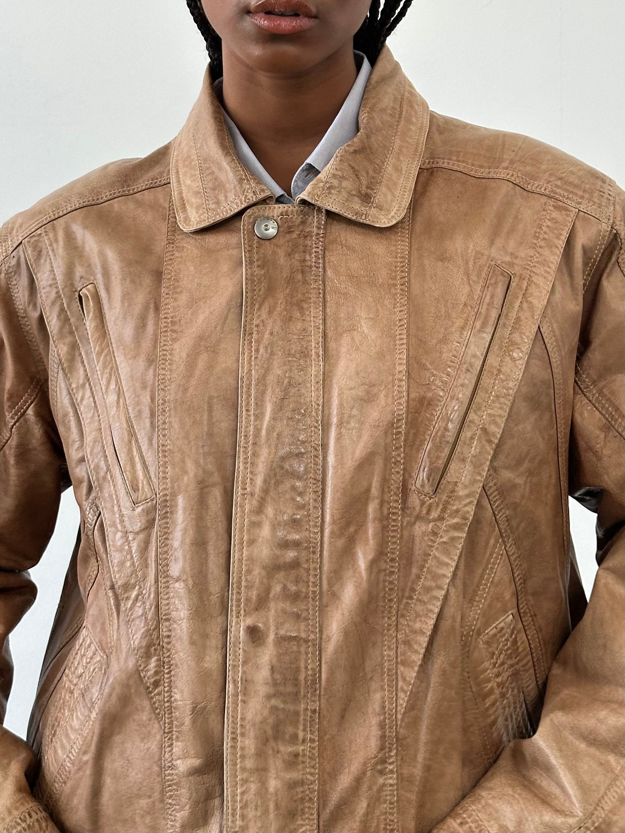 Vintage 1990s leather bomber jacket in size L, featuring classic design and distressed brown leather, styled with a ribbed collar.