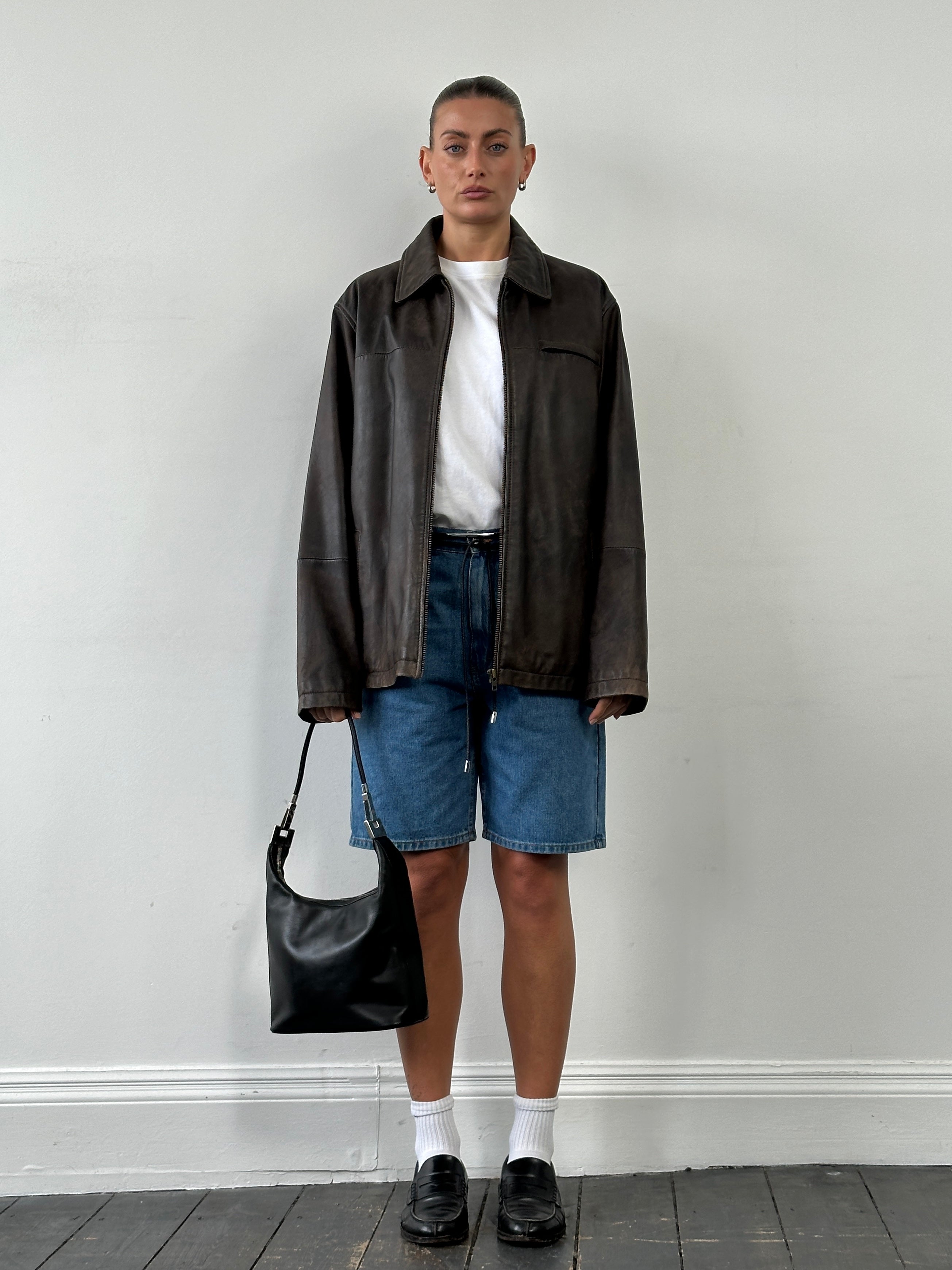 Vintage minimal aged leather jacket in XL size, featuring a classic leather design with a worn, vintage look.