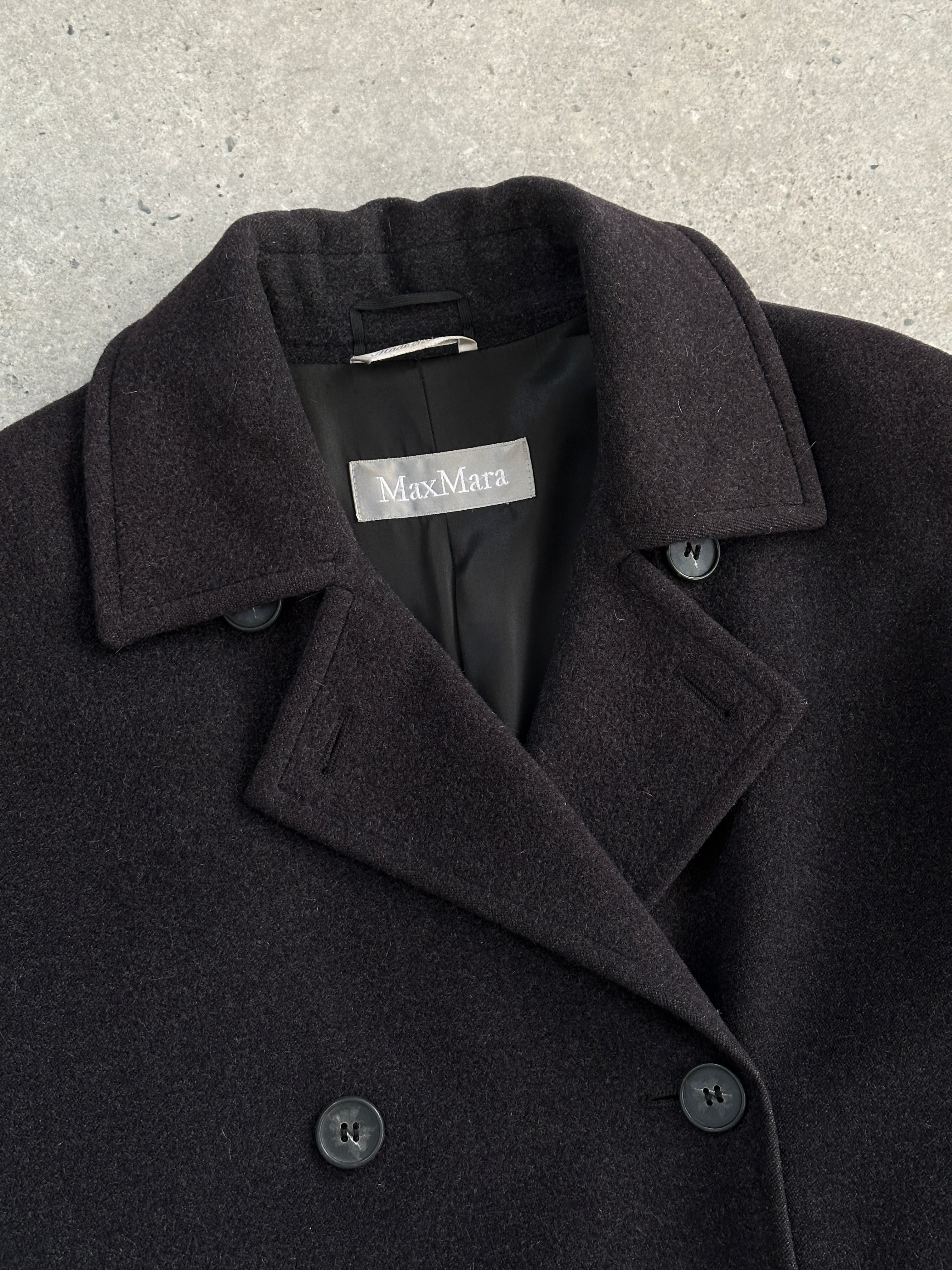 Max Mara pure wool double-breasted coat in size M, tailored fit with classic lapels and button details, shown on a hanger.
