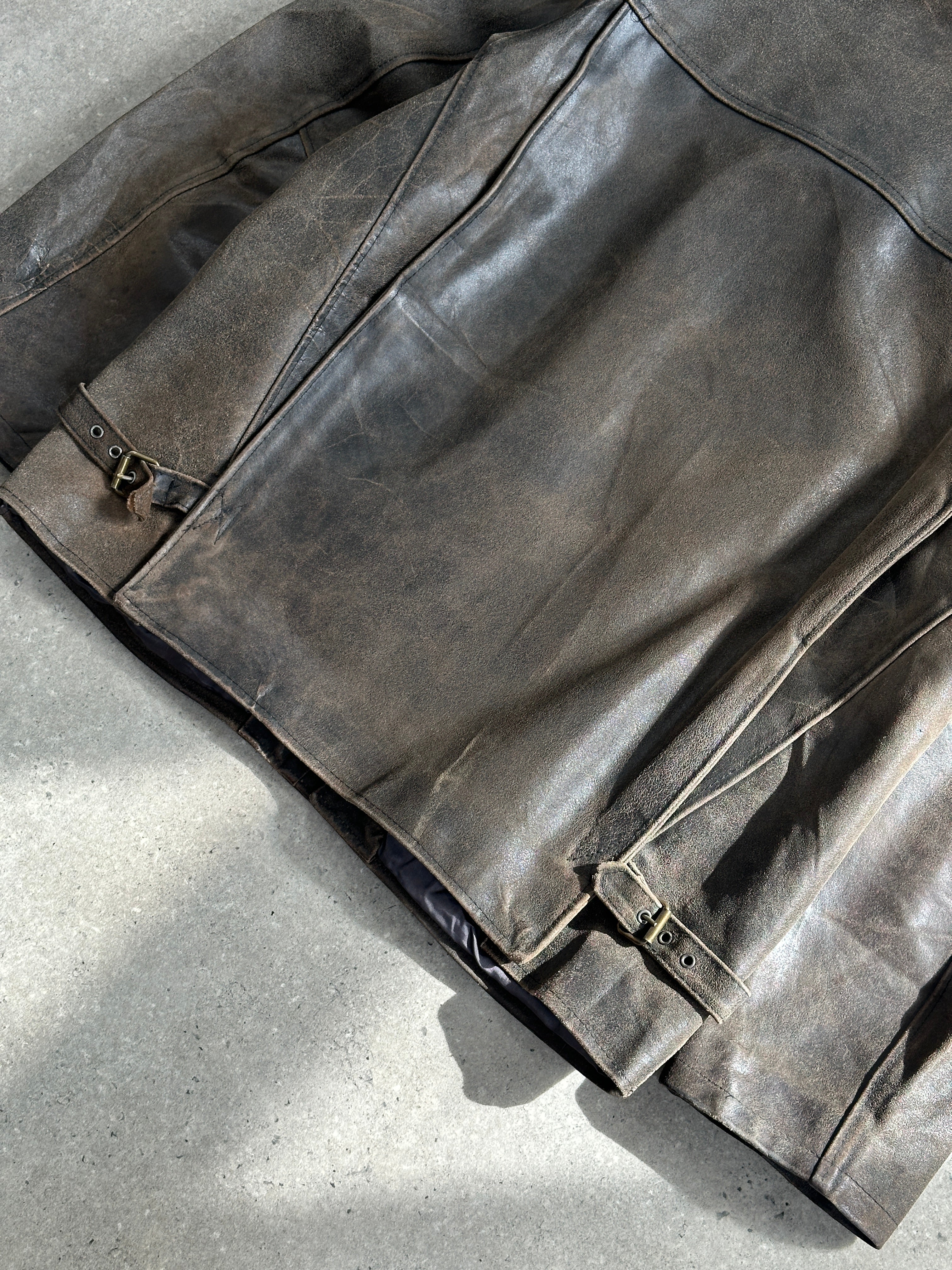 Vintage 1980s distressed leather jacket in XL, showing worn leather, classic collar, and front zipper detail.