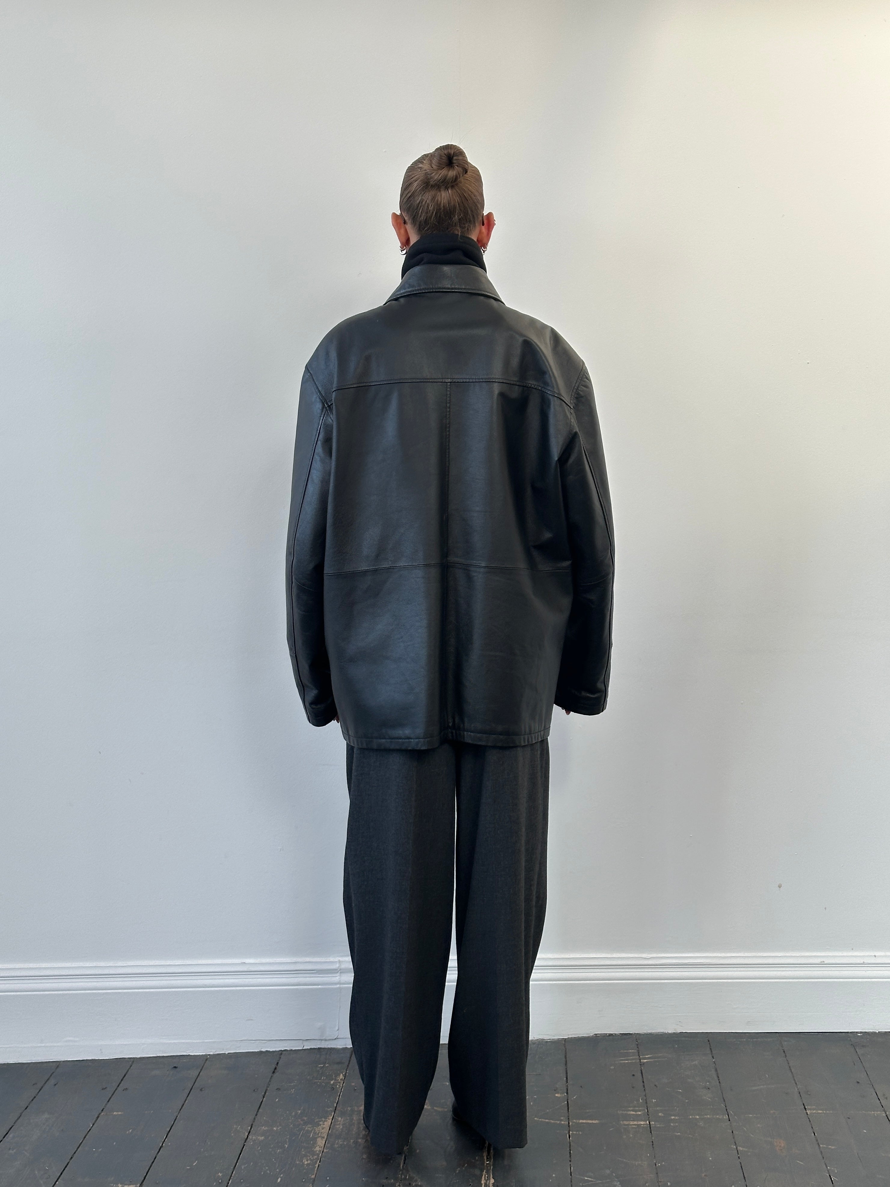 Vintage 1990s XXL leather jacket with funnel neck, classic vintage style, shown in black leather with detailed stitching.