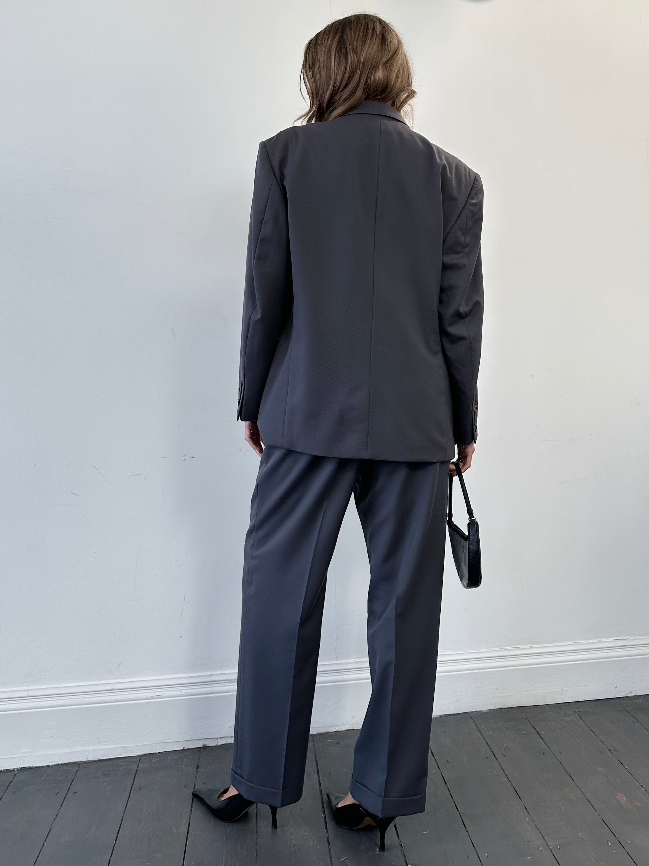 Christian Dior wool single-breasted suit jumpsuit in size 42S/W34, tailored fit with classic lapel and button closure.