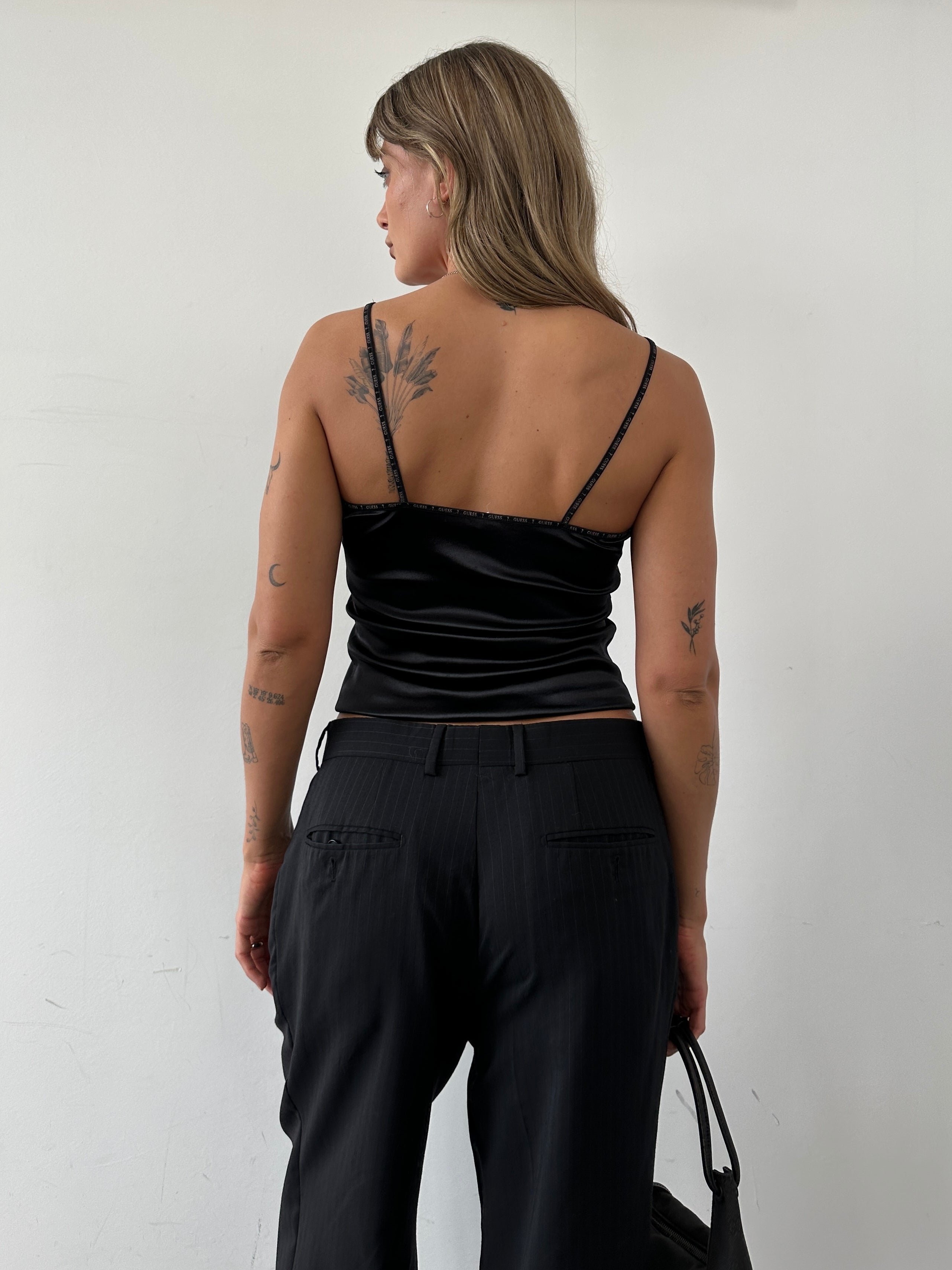 Guess stretch spaghetti cami top in black, fitted sleeveless design with thin straps and smooth fabric.