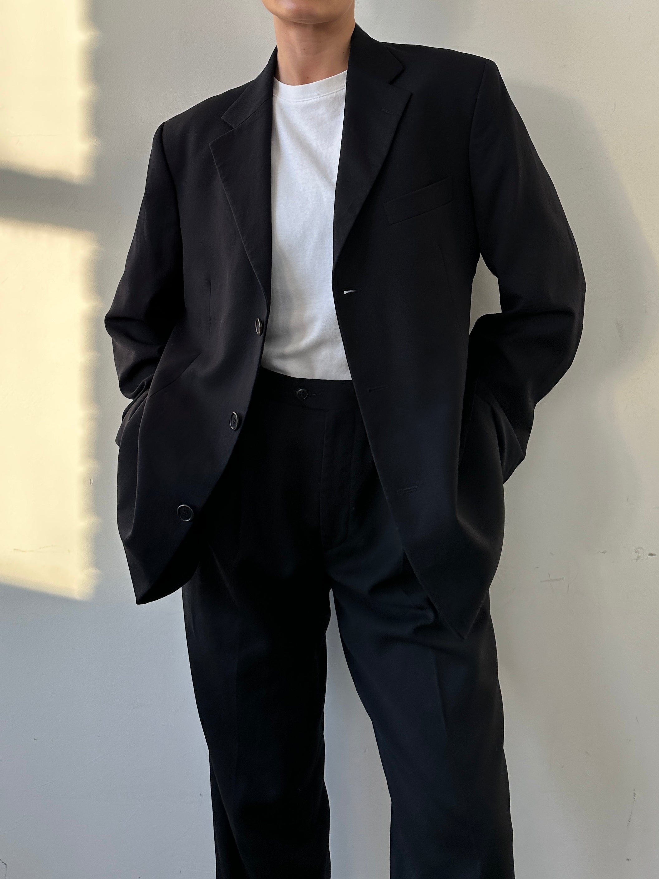 Yves Saint Laurent pure wool single-breasted blazer in black, tailored fit, showing lapels and button details.