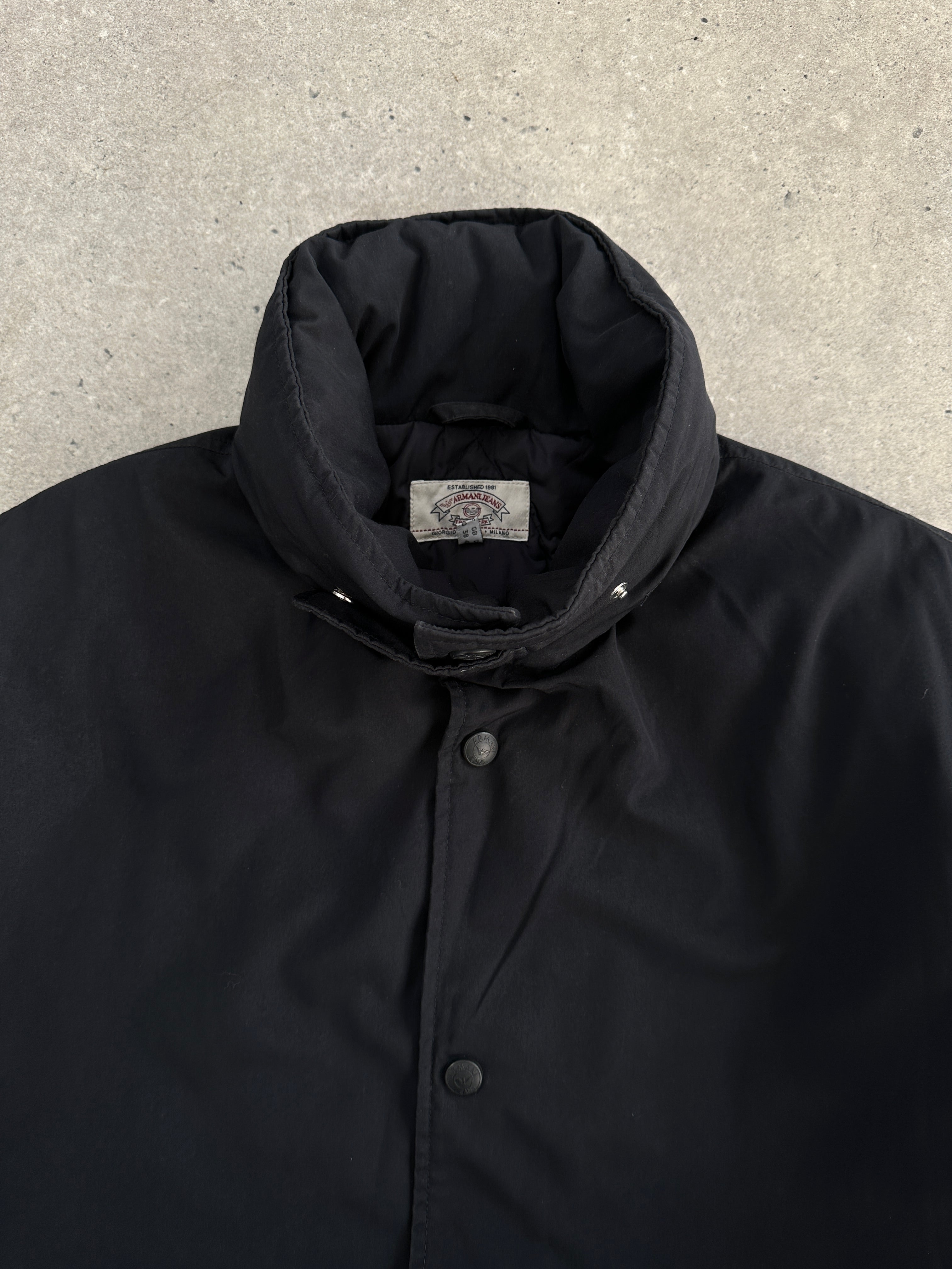 Armani Jeans padded hooded jacket in XL/XXL, black with front zip and quilted design, suitable for cold weather.
