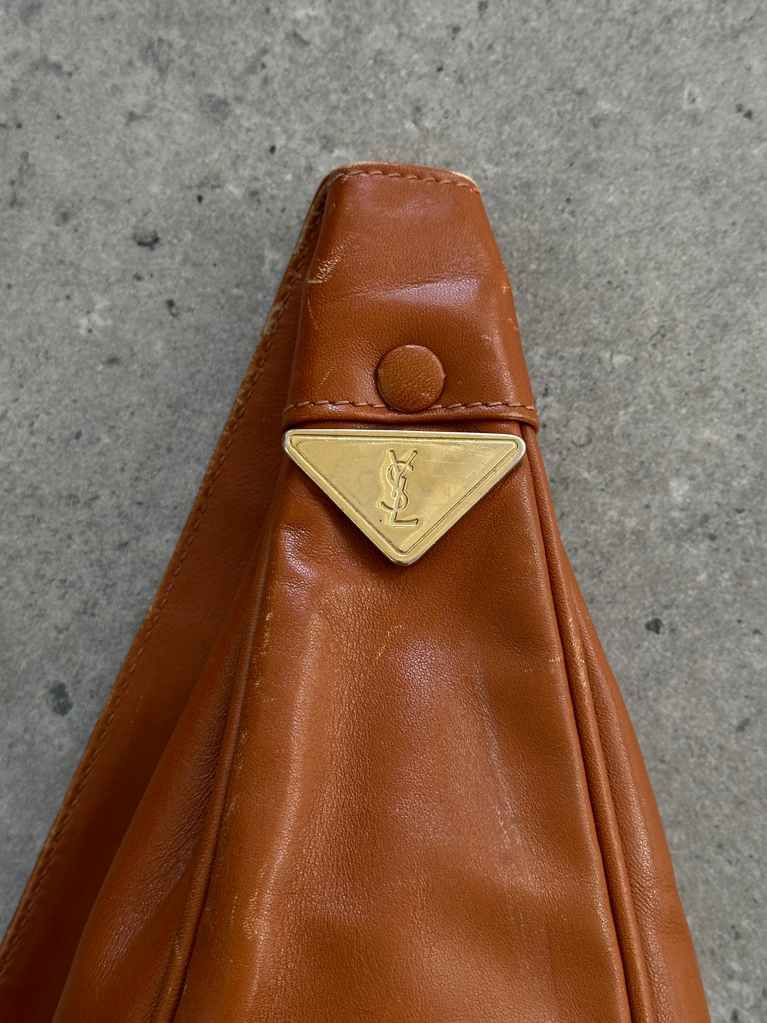 Yves Saint Laurent Paris 80s leather sling bag with sleek design, featuring a structured shape and stylish strap.