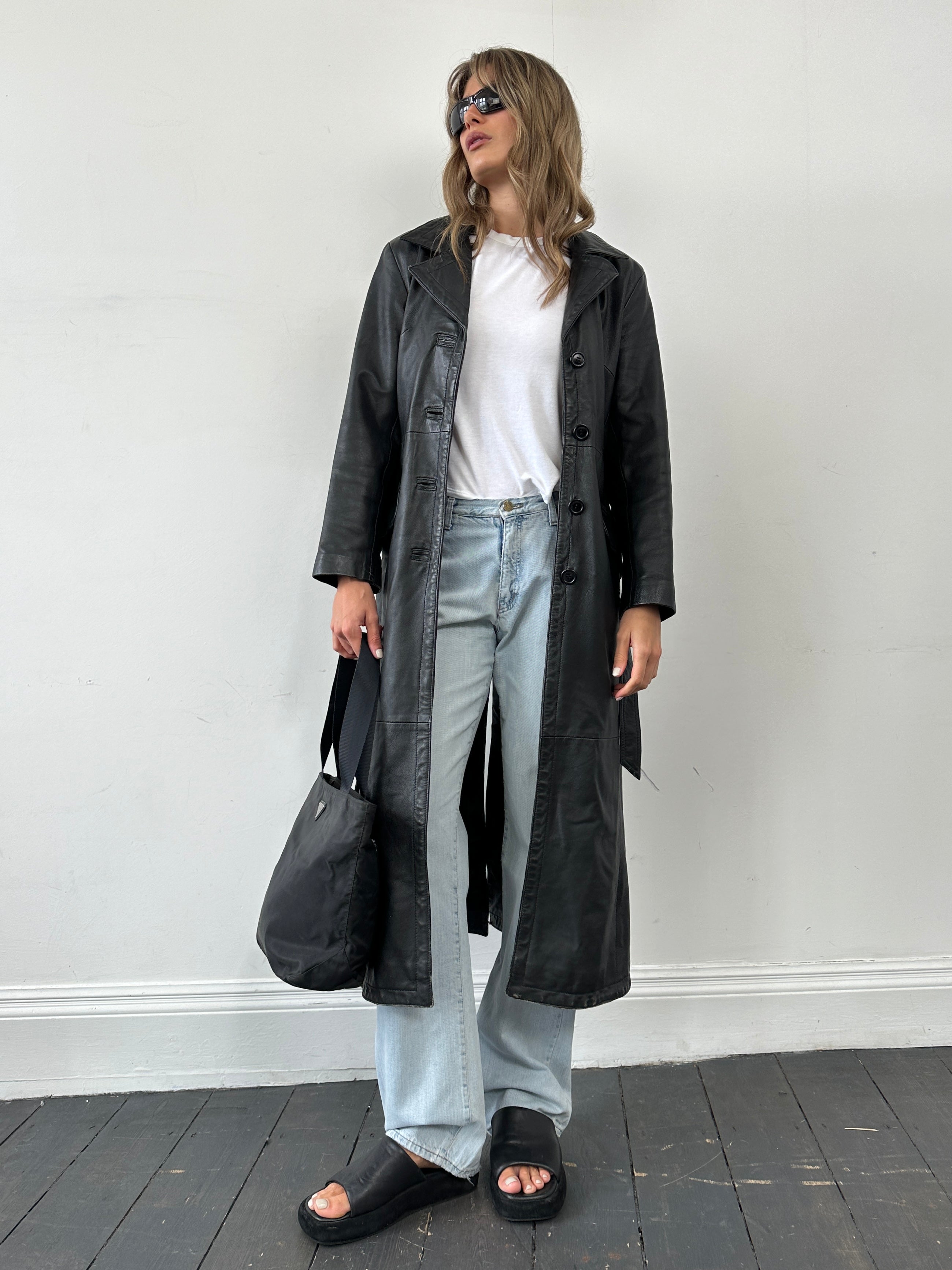 Prada 1997 nylon shoulder bag featuring a sleek design, adjustable strap, and signature Prada logo on the front.