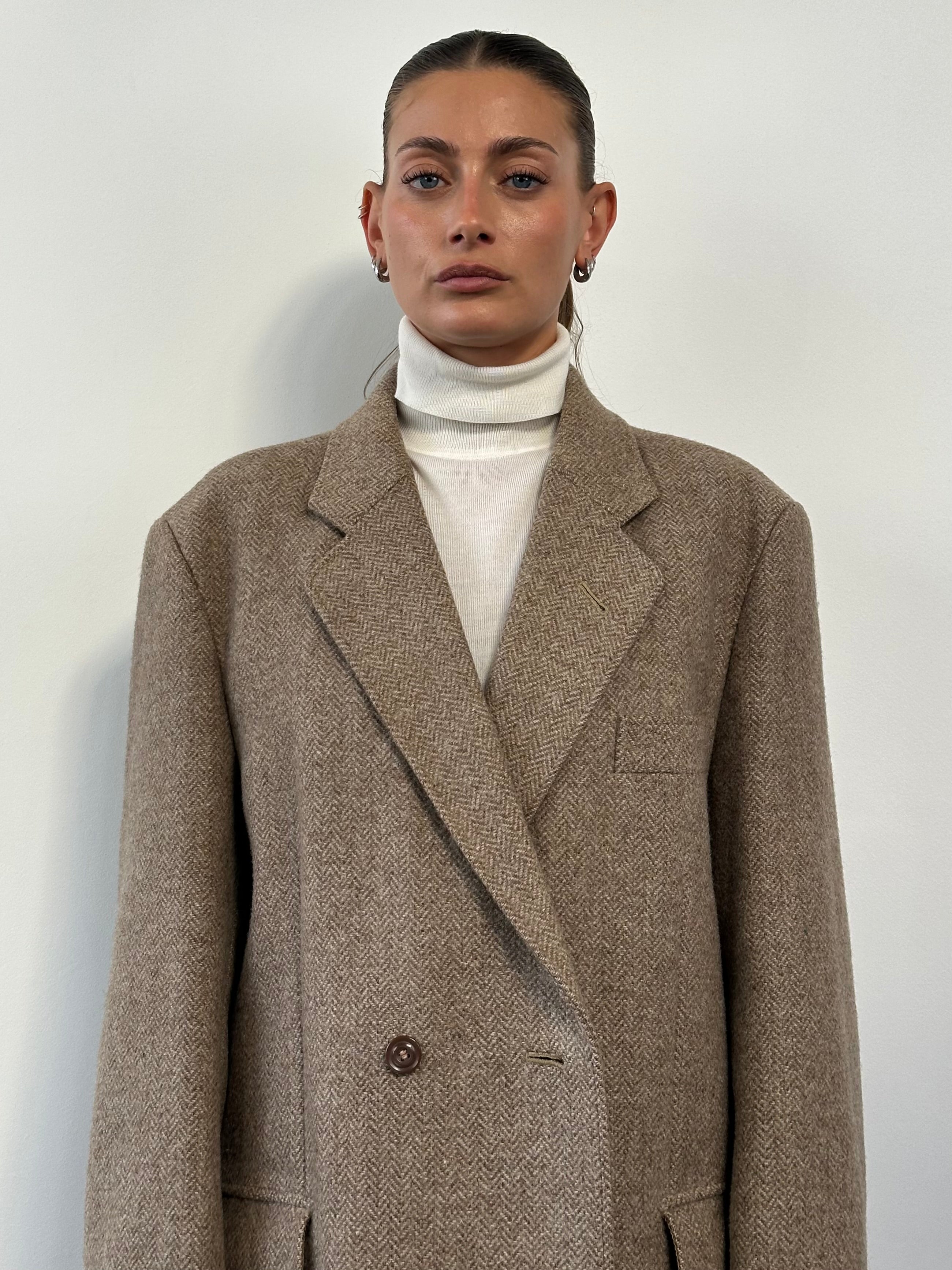 Vintage wool herringbone double-breasted coat in XL size, featuring a classic design with buttons and tailored fit.