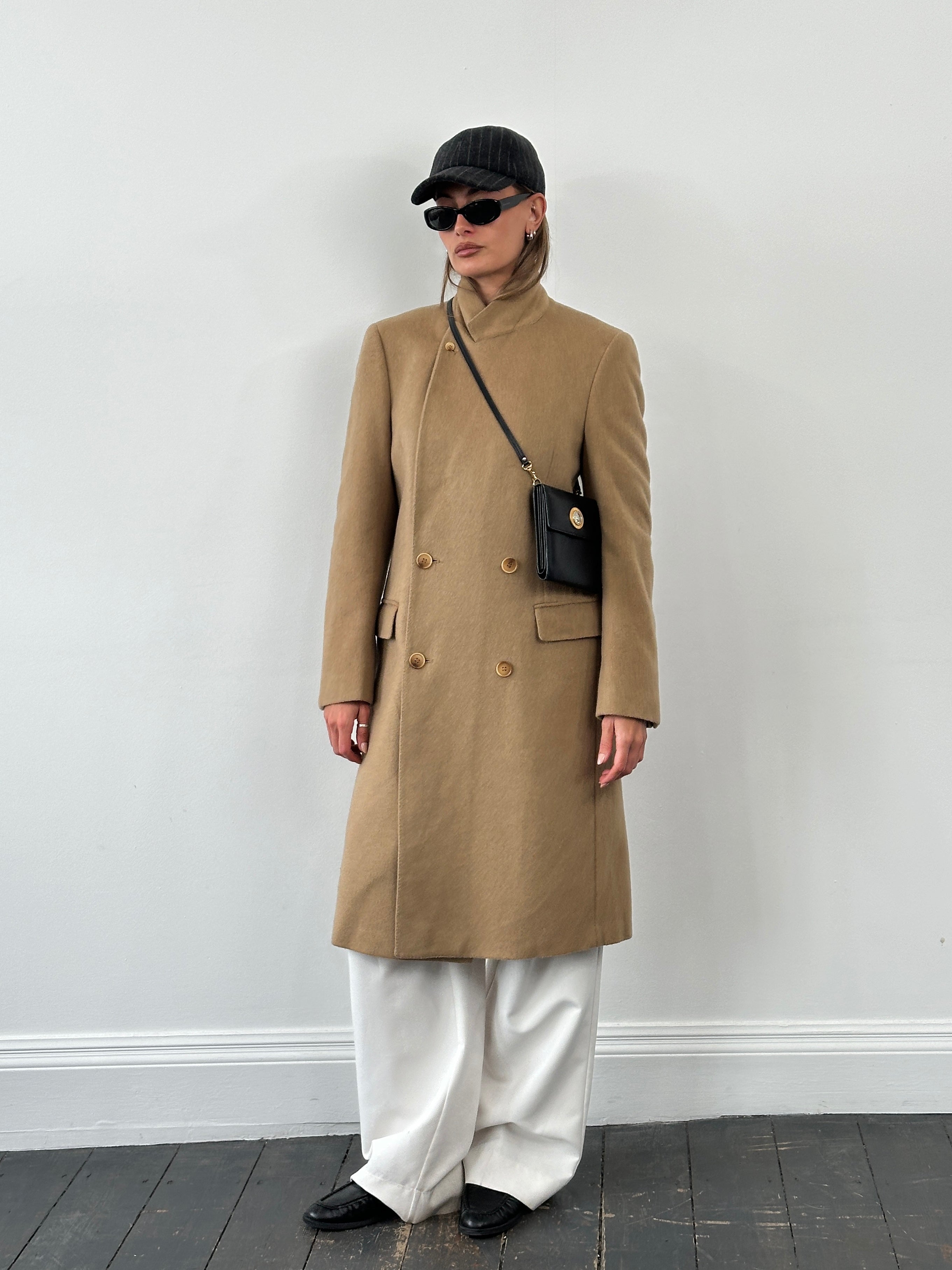 Vintage 1990s wool double-breasted high neck coat in size L, featuring classic design and textured fabric, displayed on a hanger.