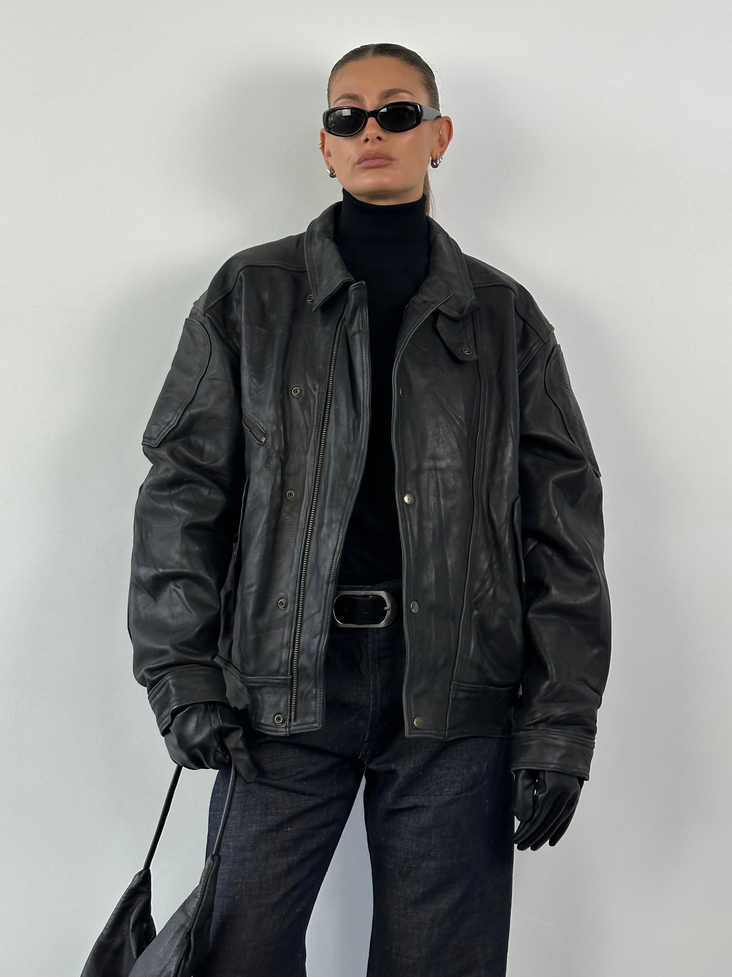 Vintage leather jacket in XL size, classic design with aged leather texture, featuring a front zipper and collar.