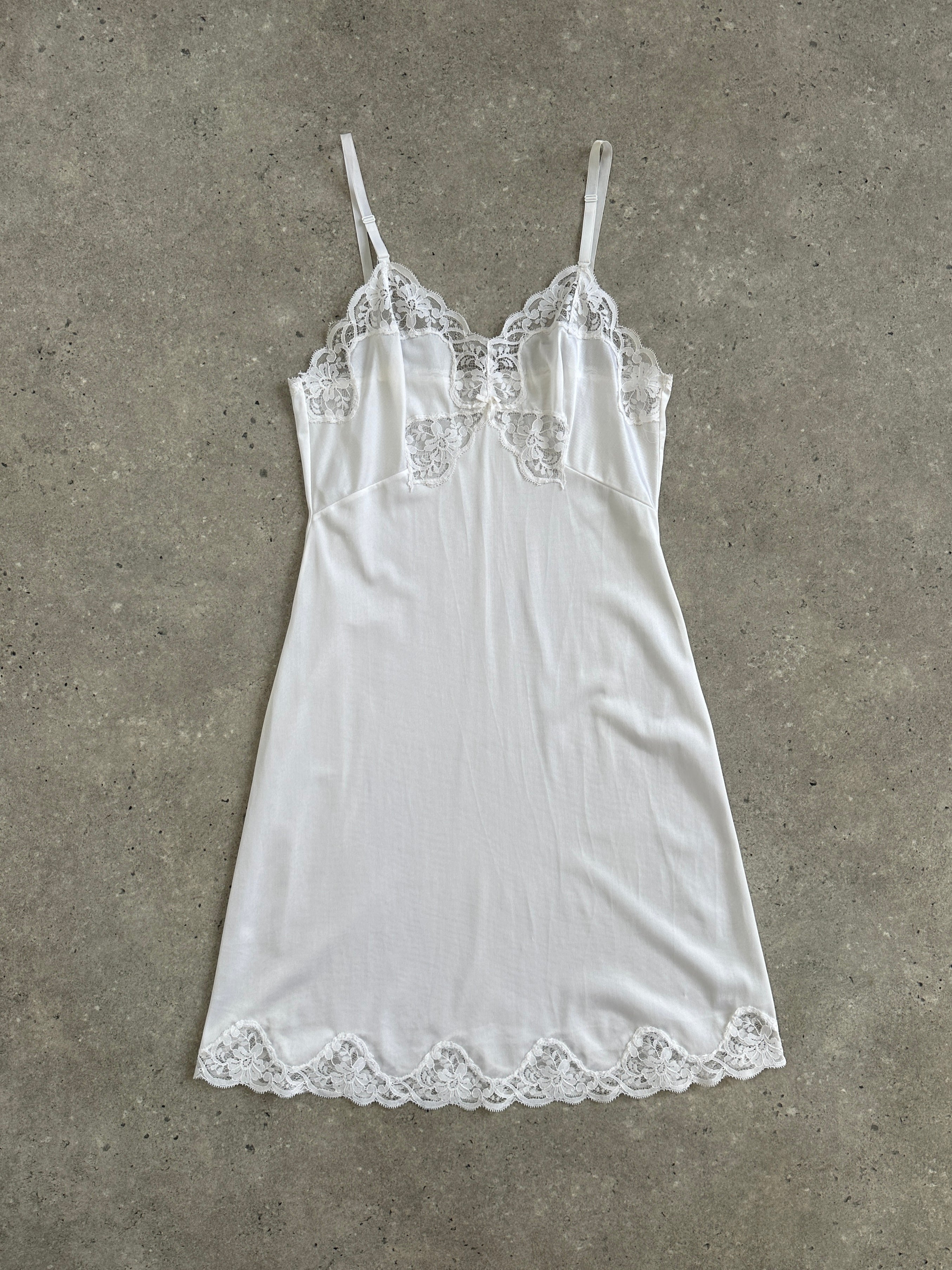 Vintage 1990s lace sheer mini slip dress in XS, featuring delicate lace fabric and a classic vintage style.