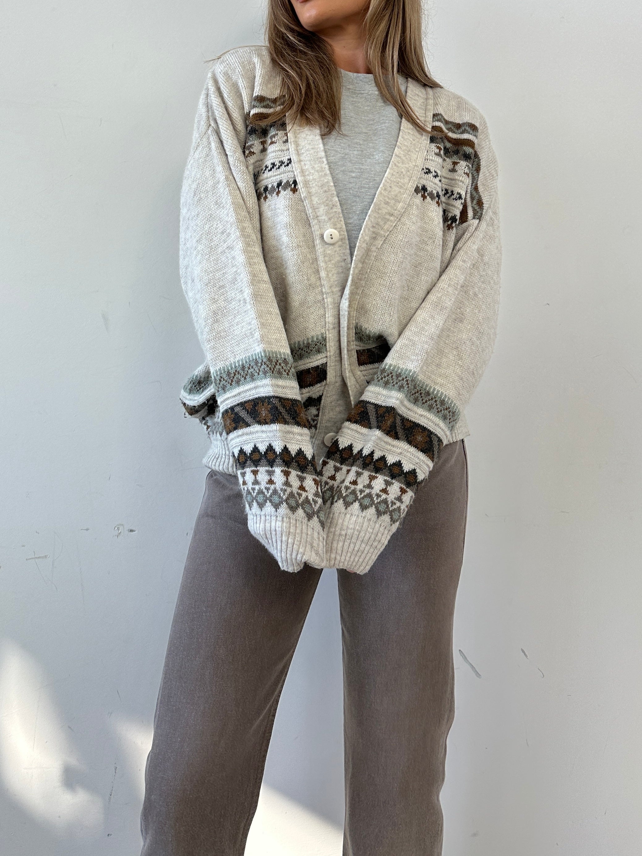 Vintage Italian vintage wool print cardigan in size M/L, featuring colorful, retro-inspired knit patterns.