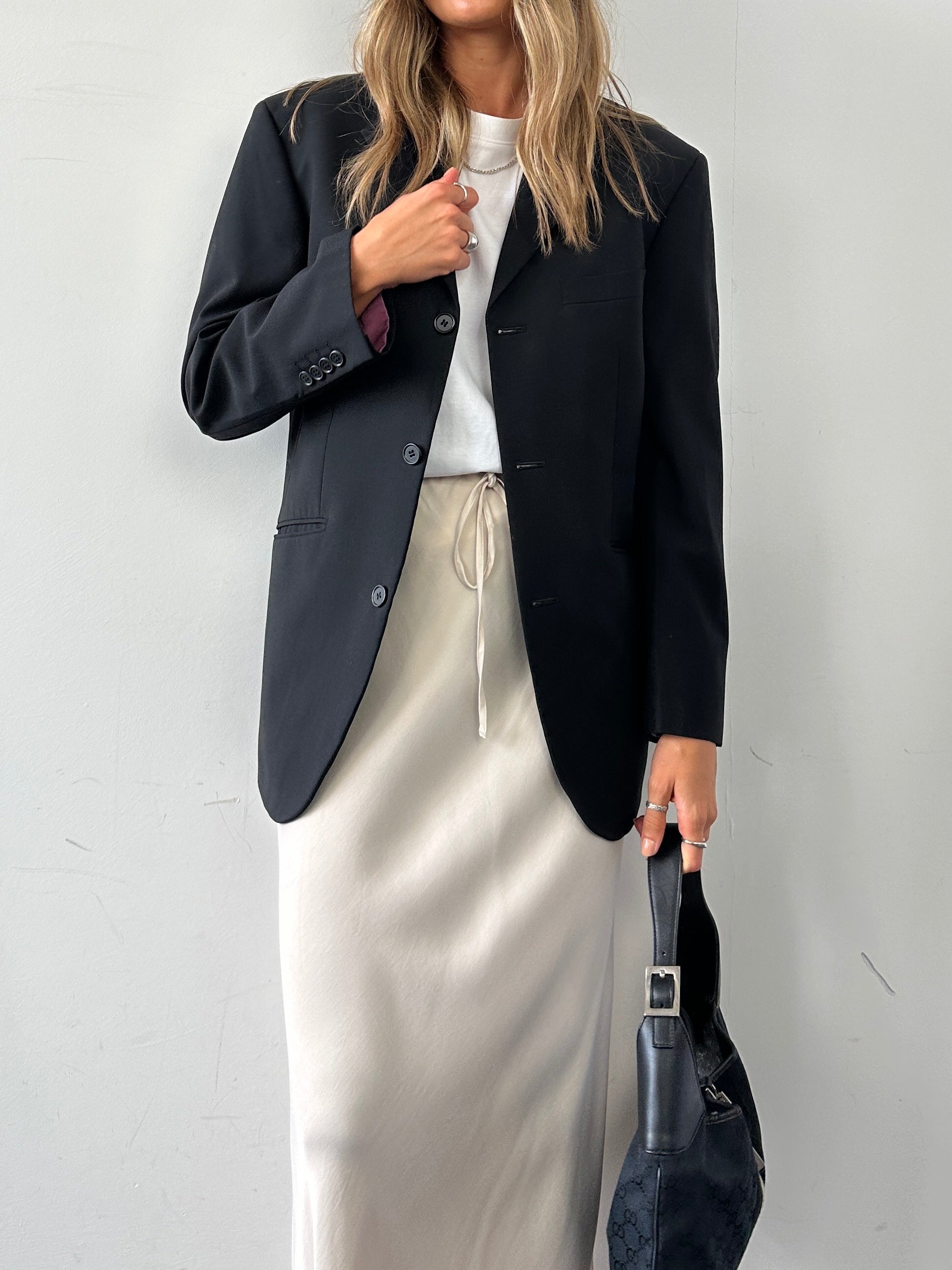Vintage single-breasted wool blazer in size M/38S, tailored fit with classic lapels and button closure, shown on a hanger.