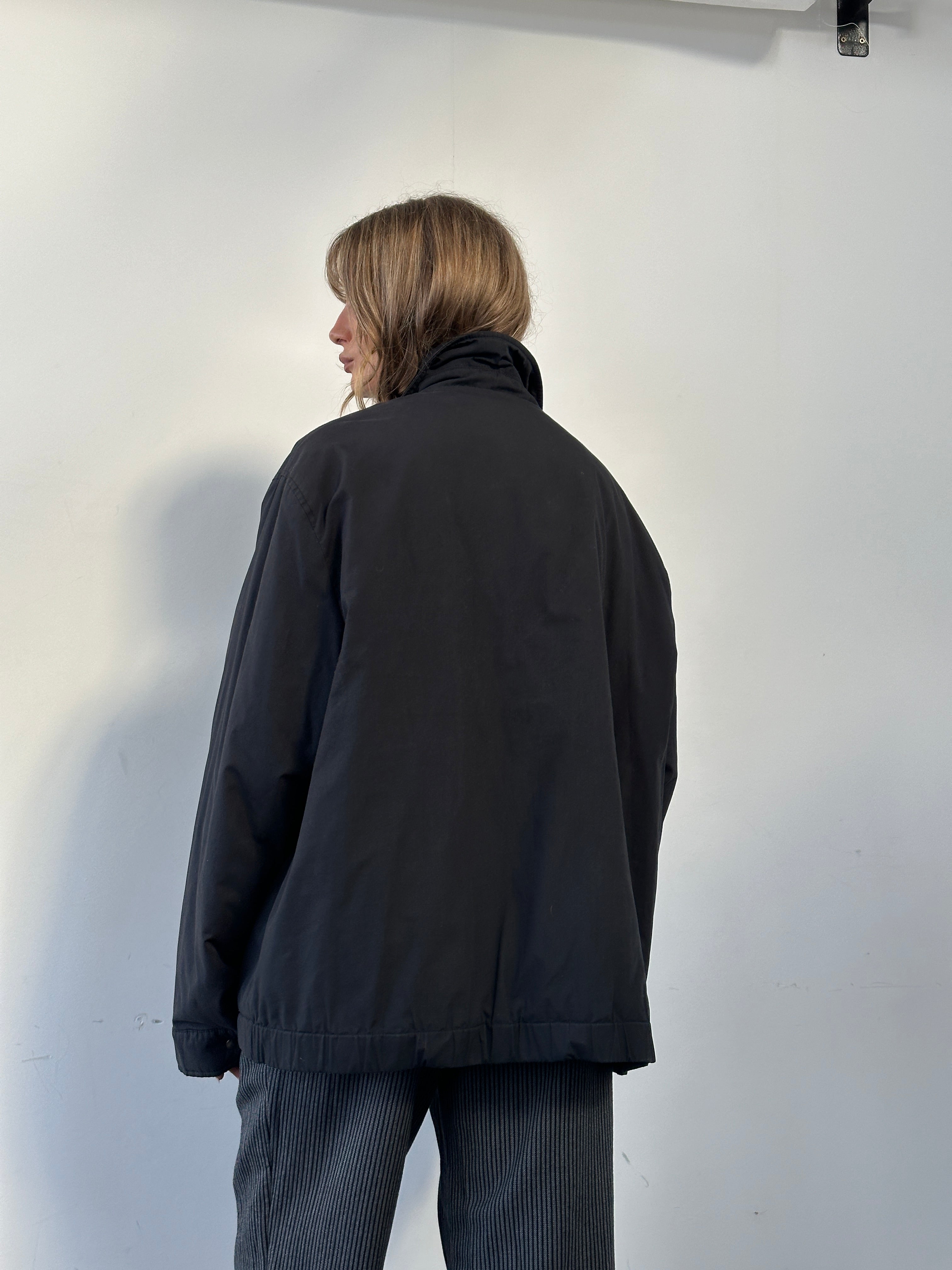 Yves Saint Laurent Harrington jacket in XXL style, black with detailed design, shown on a hanger against a neutral background.