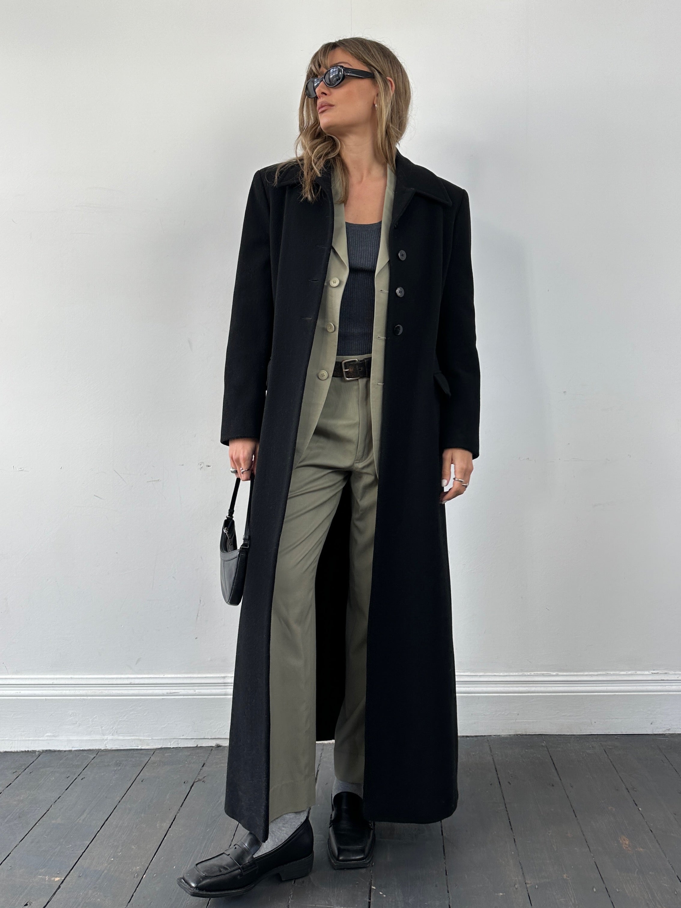 Vintage wool single-breasted A-line coat in size small, featuring classic design and tailored fit, front view showing lapel and buttons.