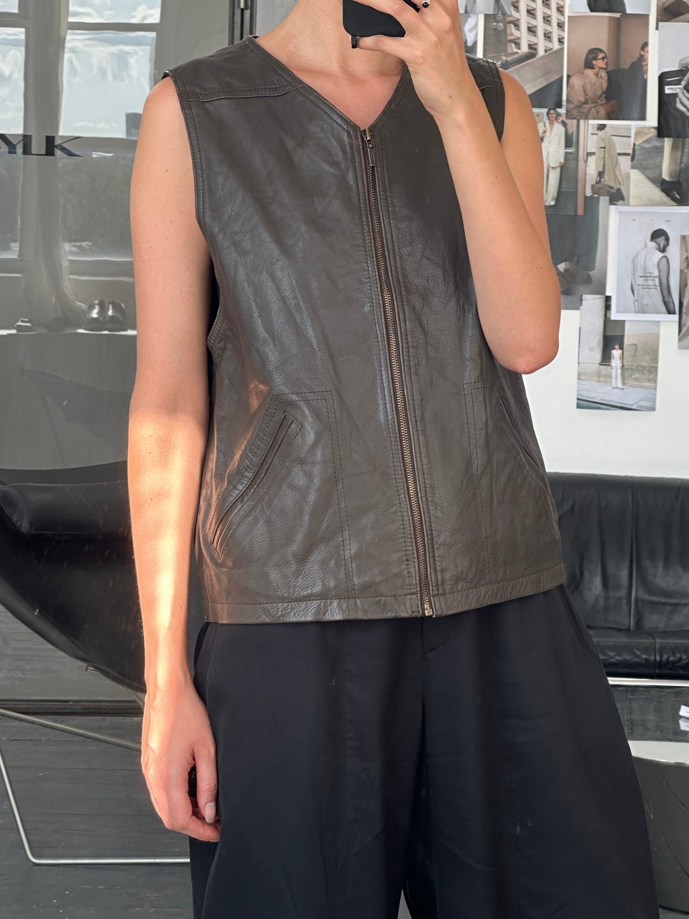 Vintage 1990s front zip leather waistcoat in size large, featuring classic design and high-quality leather detailing.
