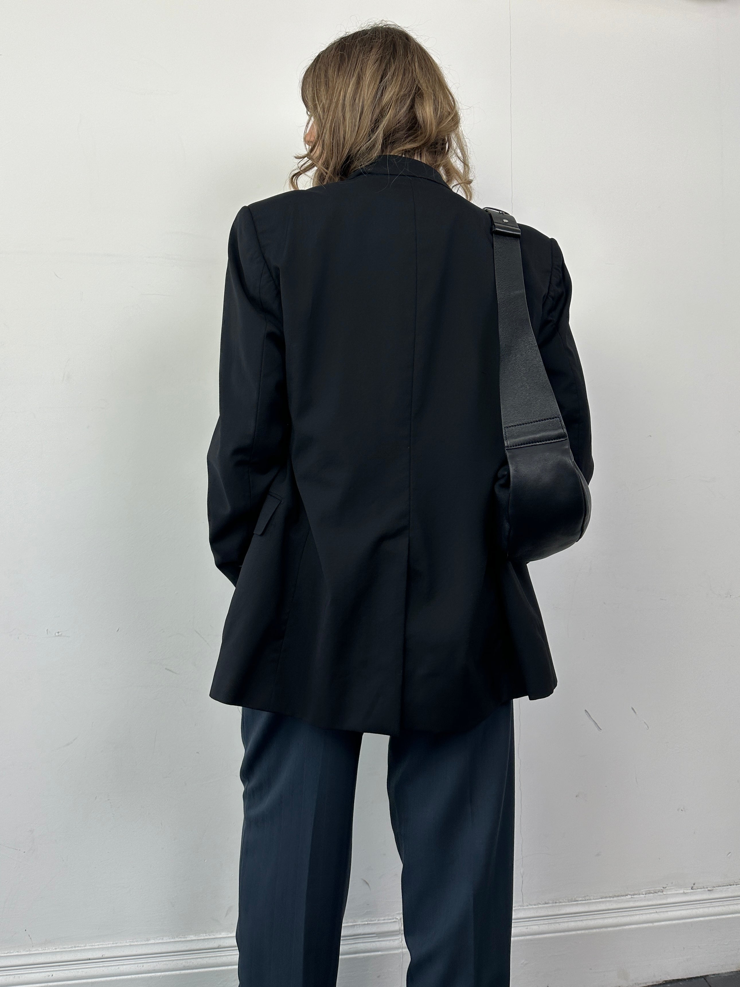 Dolce & Gabbana single-breasted virgin wool blazer in size M, featuring tailored fit and classic lapel, displayed on a mannequin.