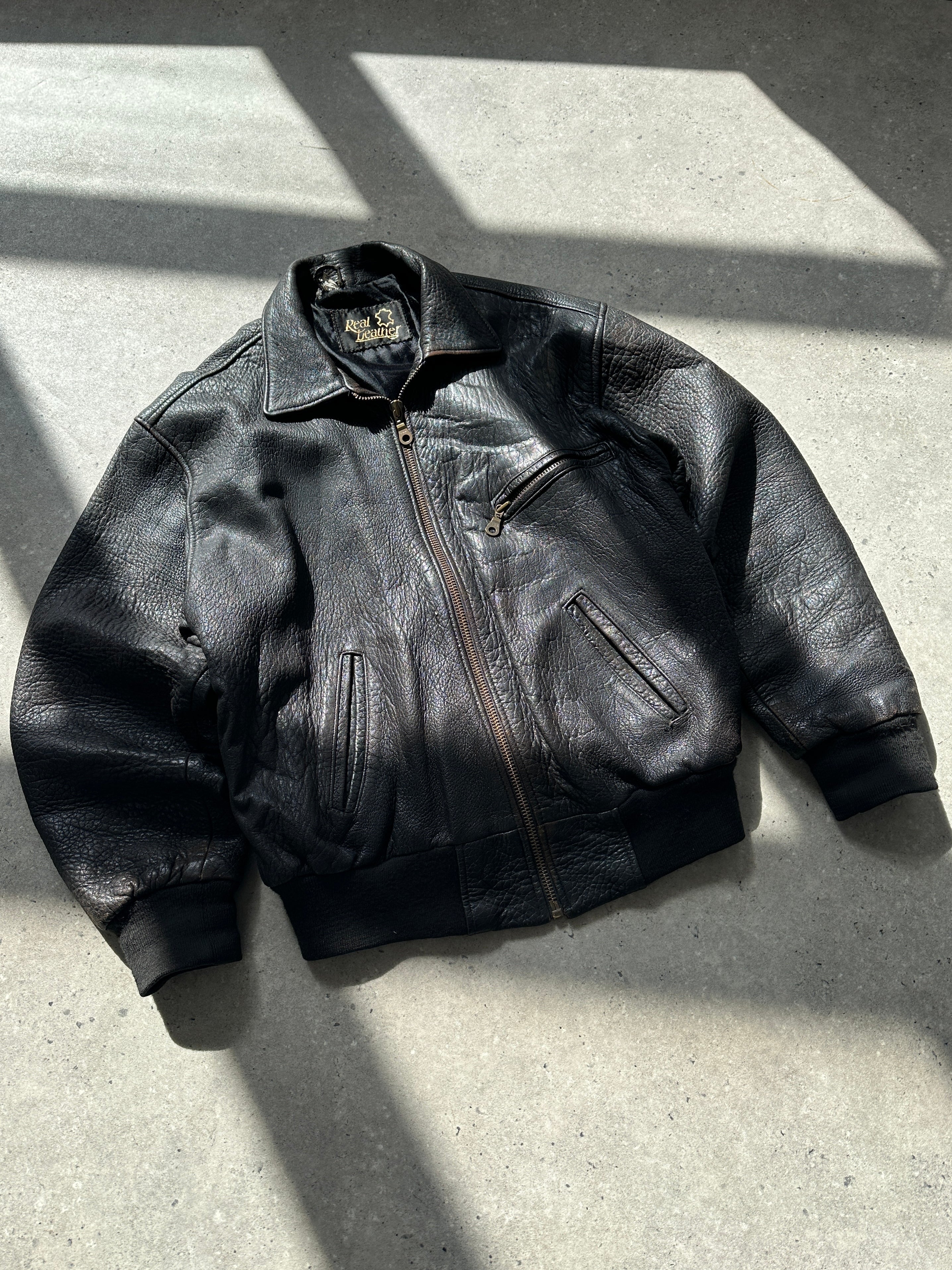 Vintage British vintage leather bomber jacket in size M, featuring classic design and aged leather details.