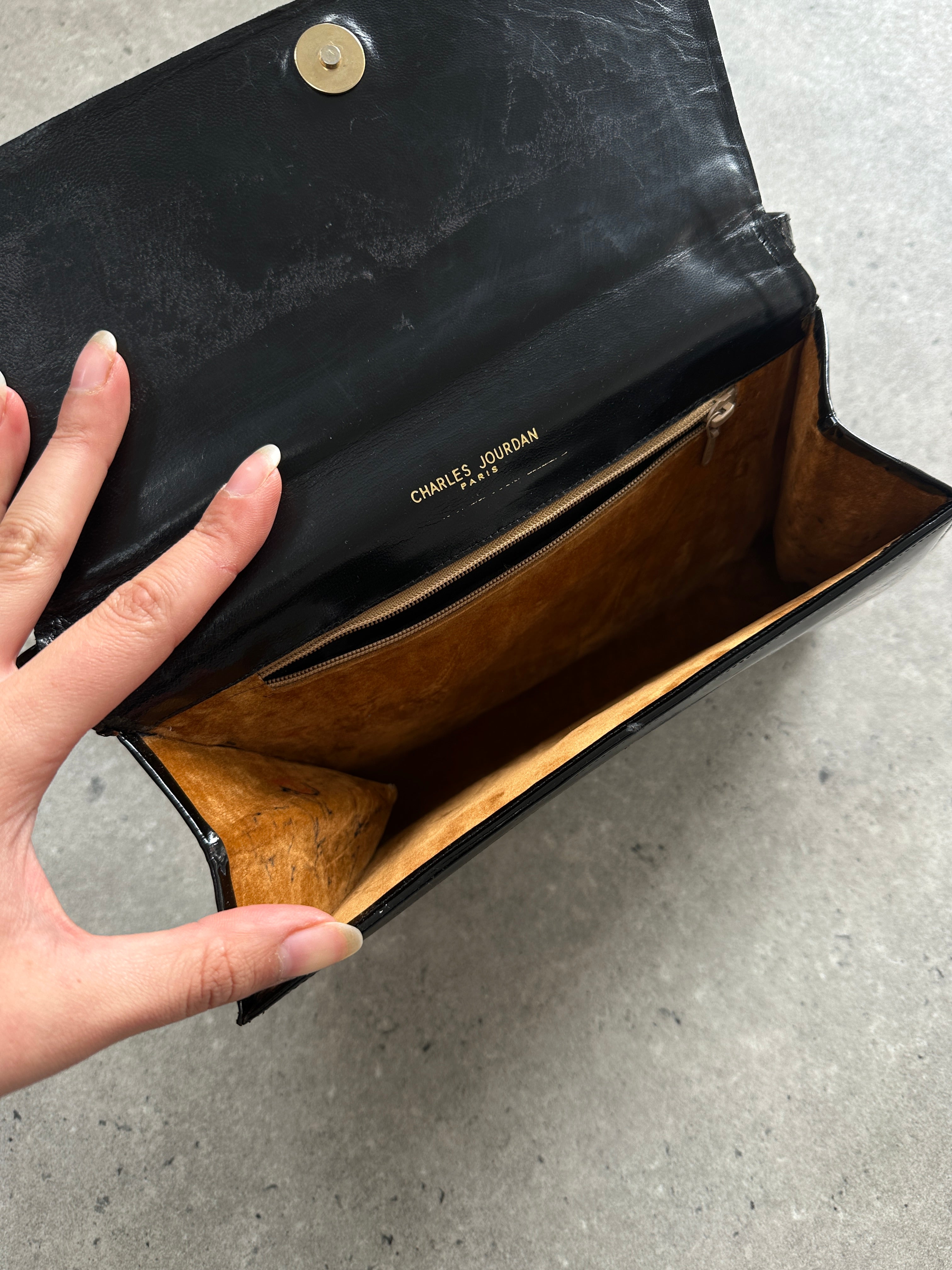 Charles Jourdan 1990s asymmetric patent crossbody bag with sleek design and bold silhouette, featuring a stylish, glossy finish.