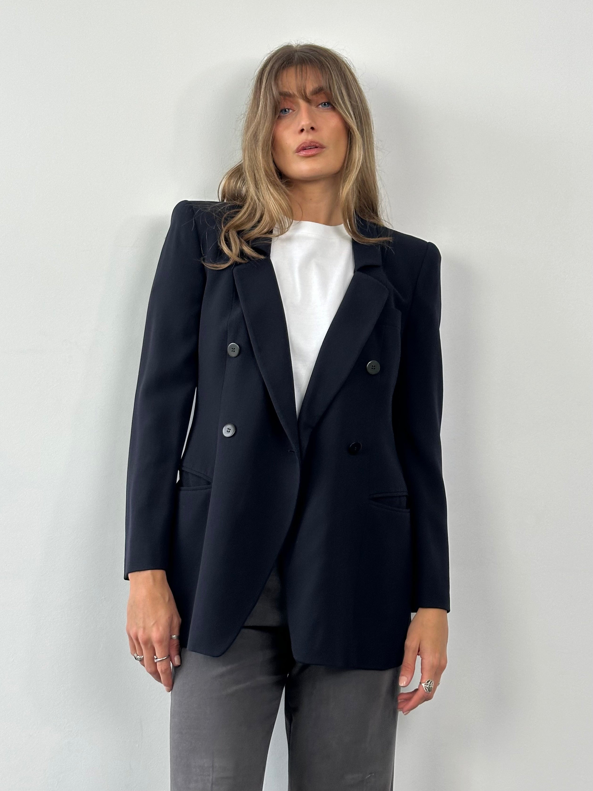 Giorgio Armani Black Label pure wool fitted blazer in black, displayed on a hanger, featuring a tailored design and classic style.