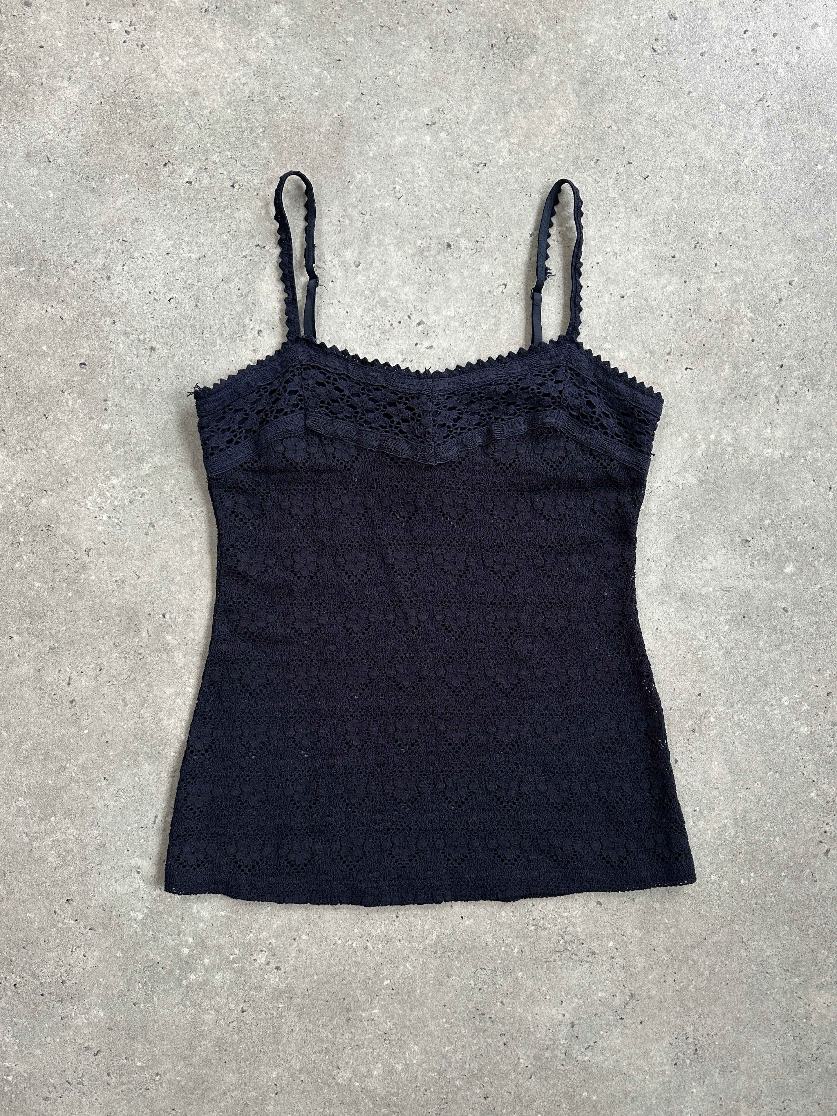 Vintage 2000s crochet cami top in black with delicate straps and intricate knit pattern, styled as a casual sleeveless top.