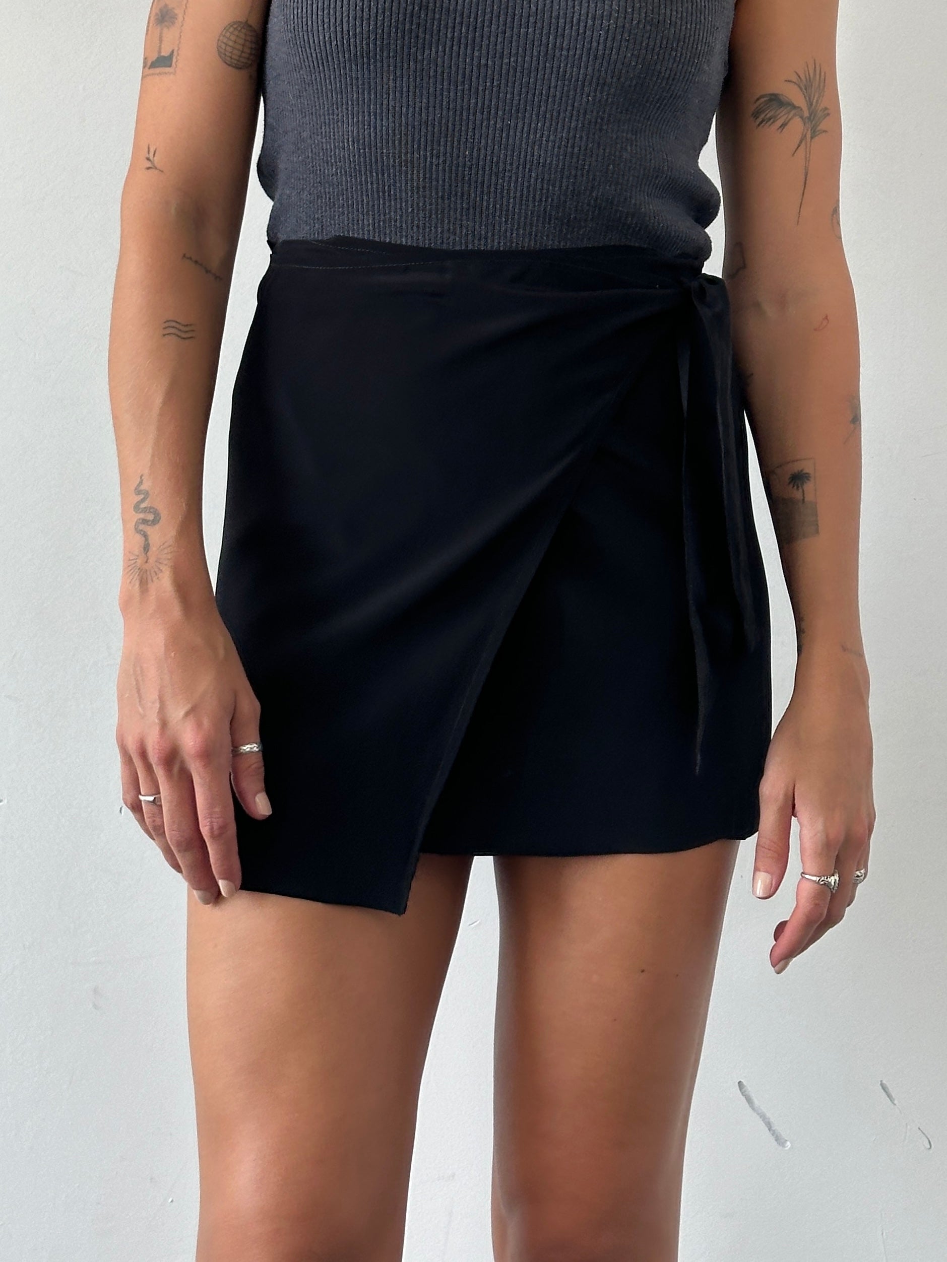 Vintage mini wrap skirt in classic design, featuring a stylish fit and versatile length, perfect for casual or dressy outfits.