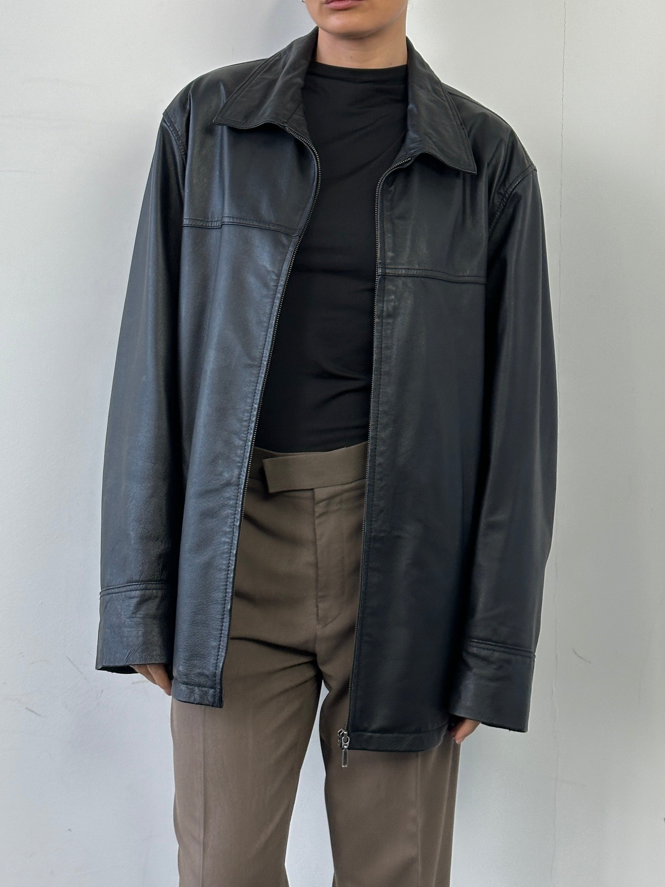 Vintage minimal leather jacket in XL size, featuring sleek design and classic style, shown on a hanger.