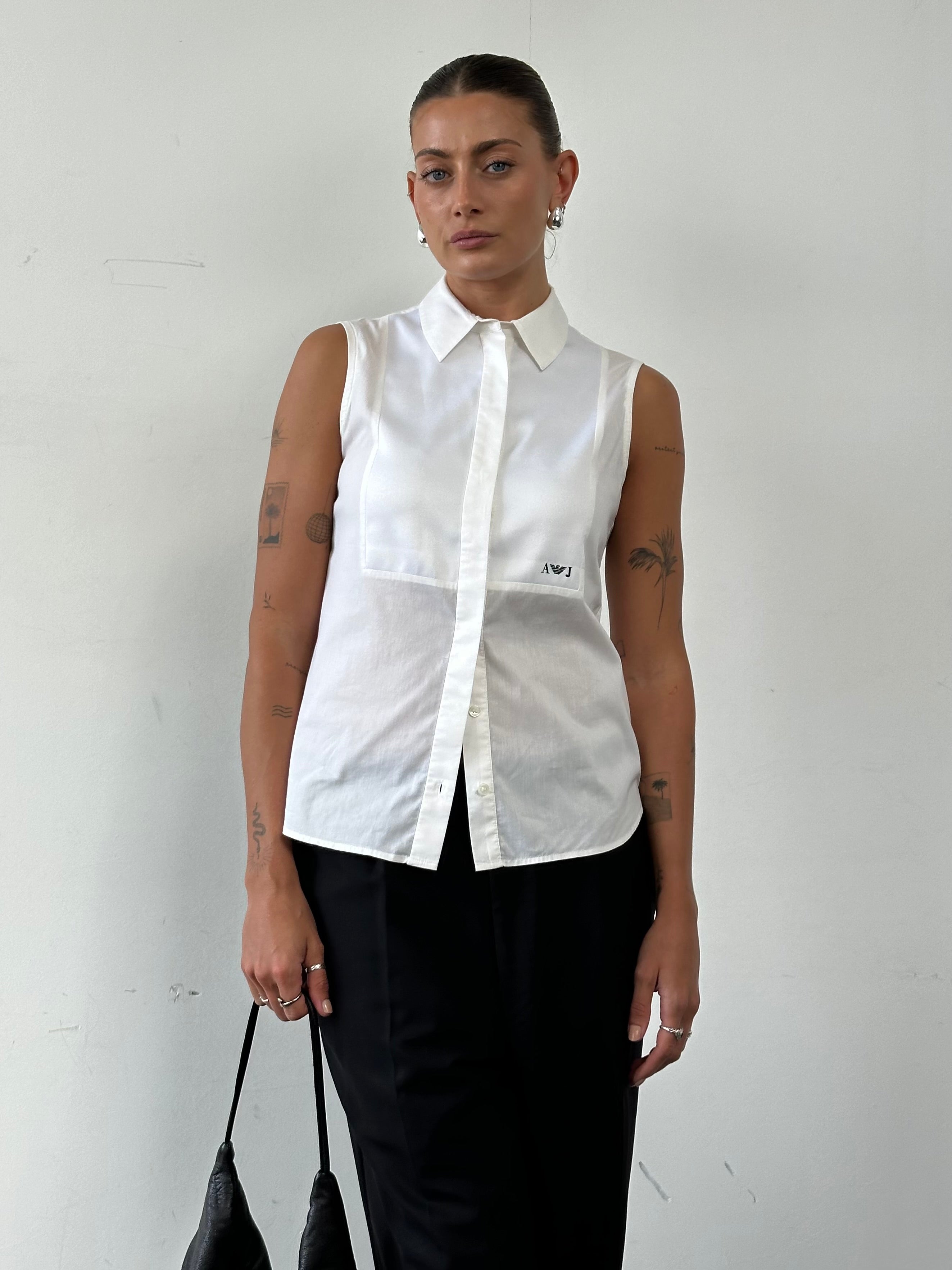 Armani Jeans sleeveless shirt in size small, featuring a stylish design with a collar and button front, perfect for casual wear.