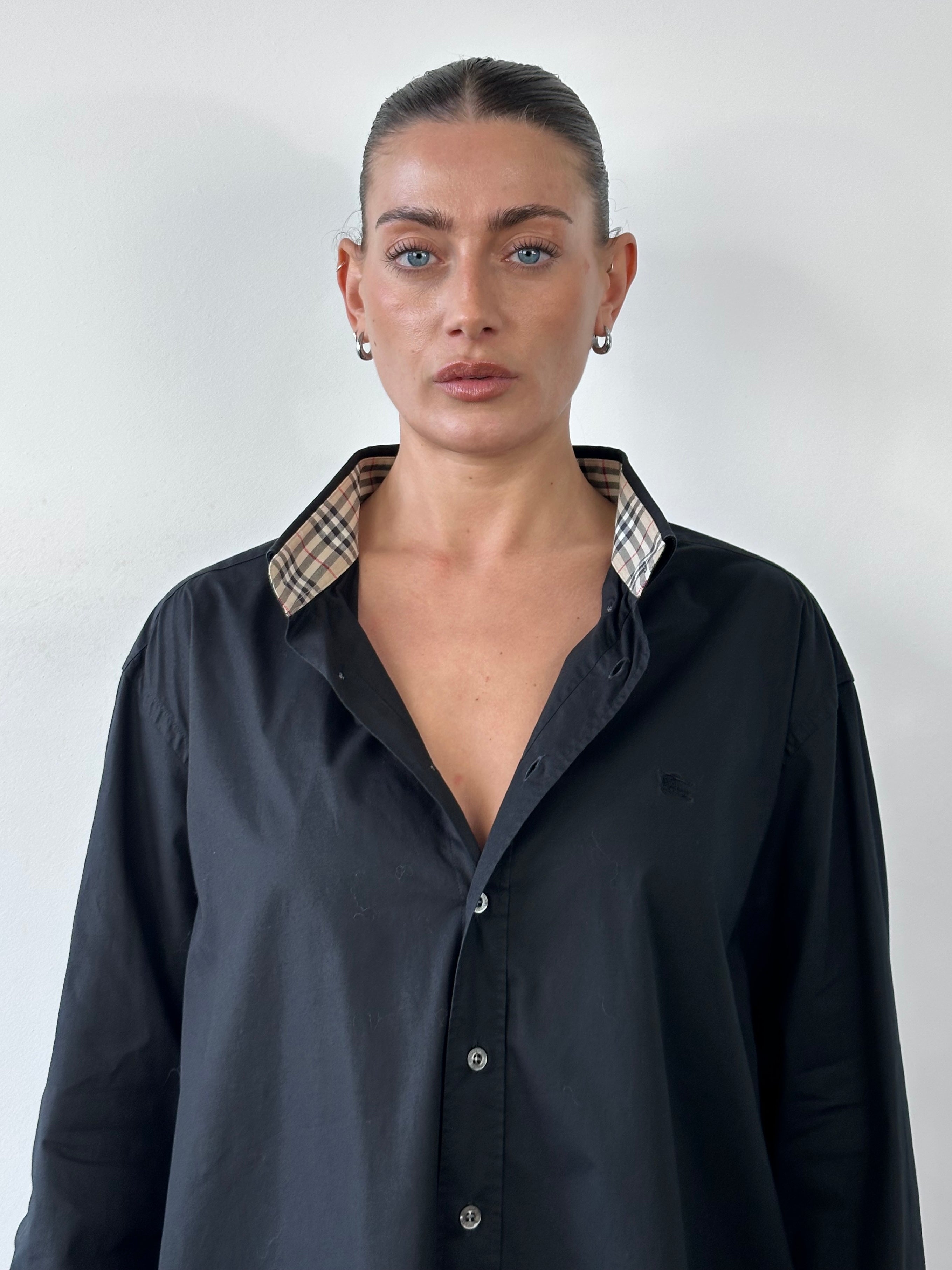 Burberry London pure cotton logo shirt in XL, featuring classic design and iconic branding, displayed on a hanger.