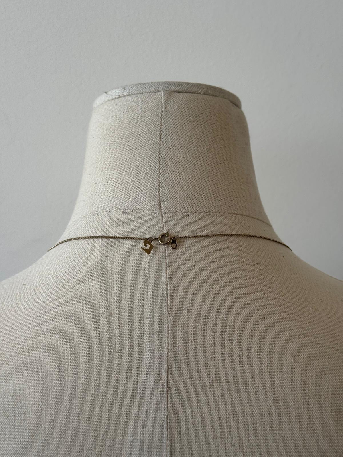Pierre Cardin 1990s gold-plated necklace with fine chain and elegant design, showcased on a neutral background