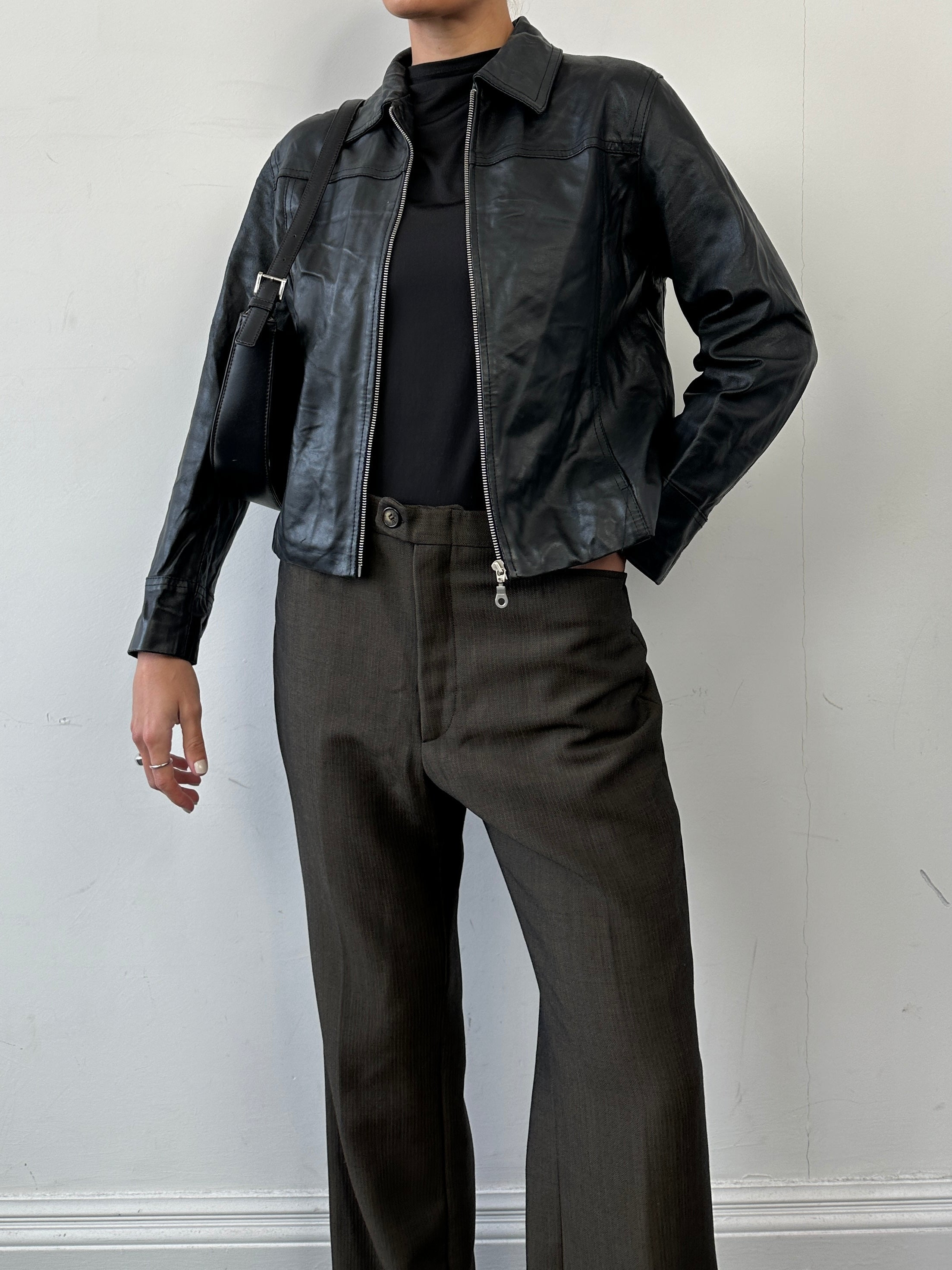 Vintage minimal leather jacket in size S featuring a zip-up front and classic design, shown on a hanger.