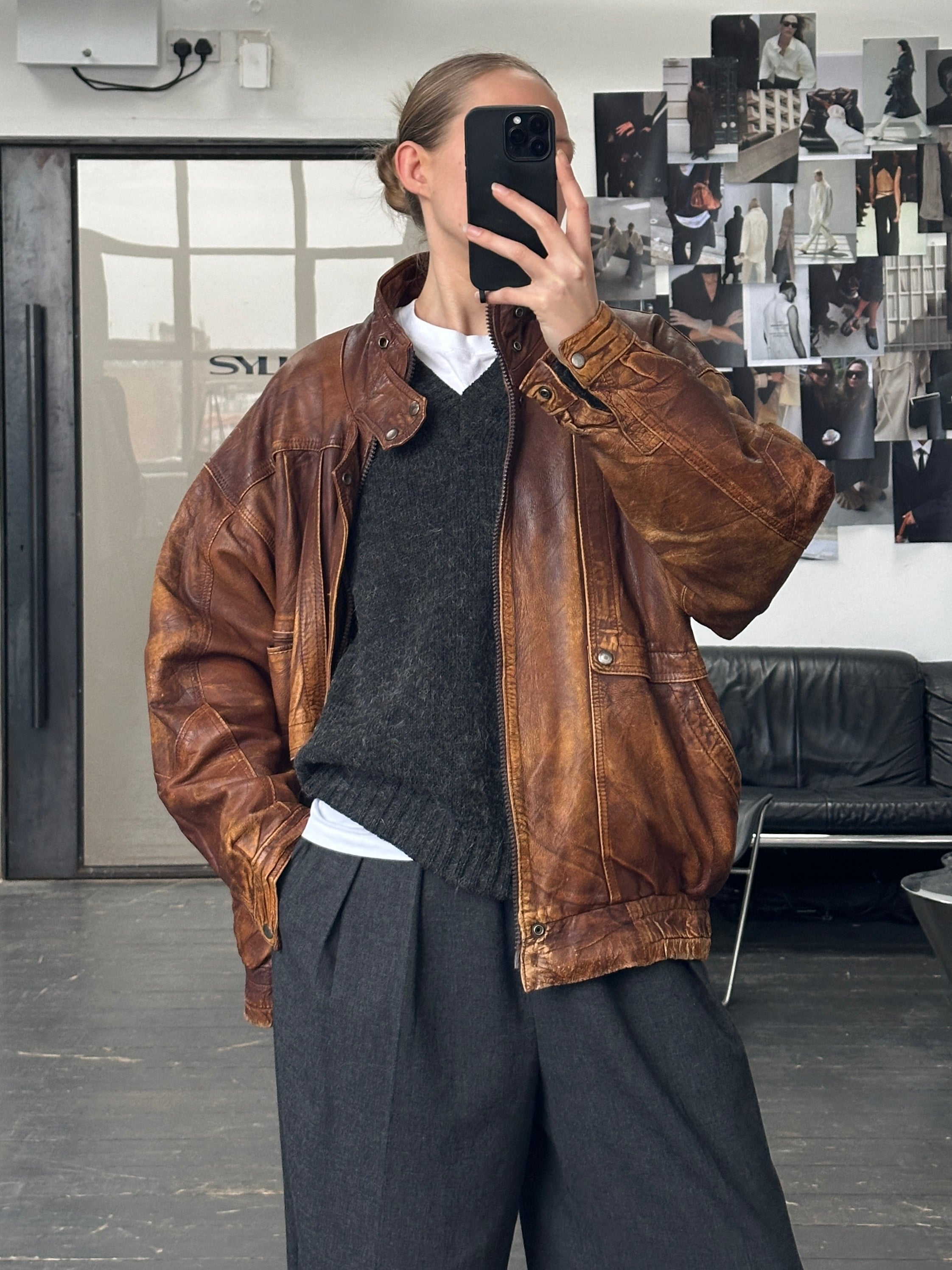 Vintage brand vintage 1990s aged leather bomber jacket in XL with classic design and distressed leather texture.