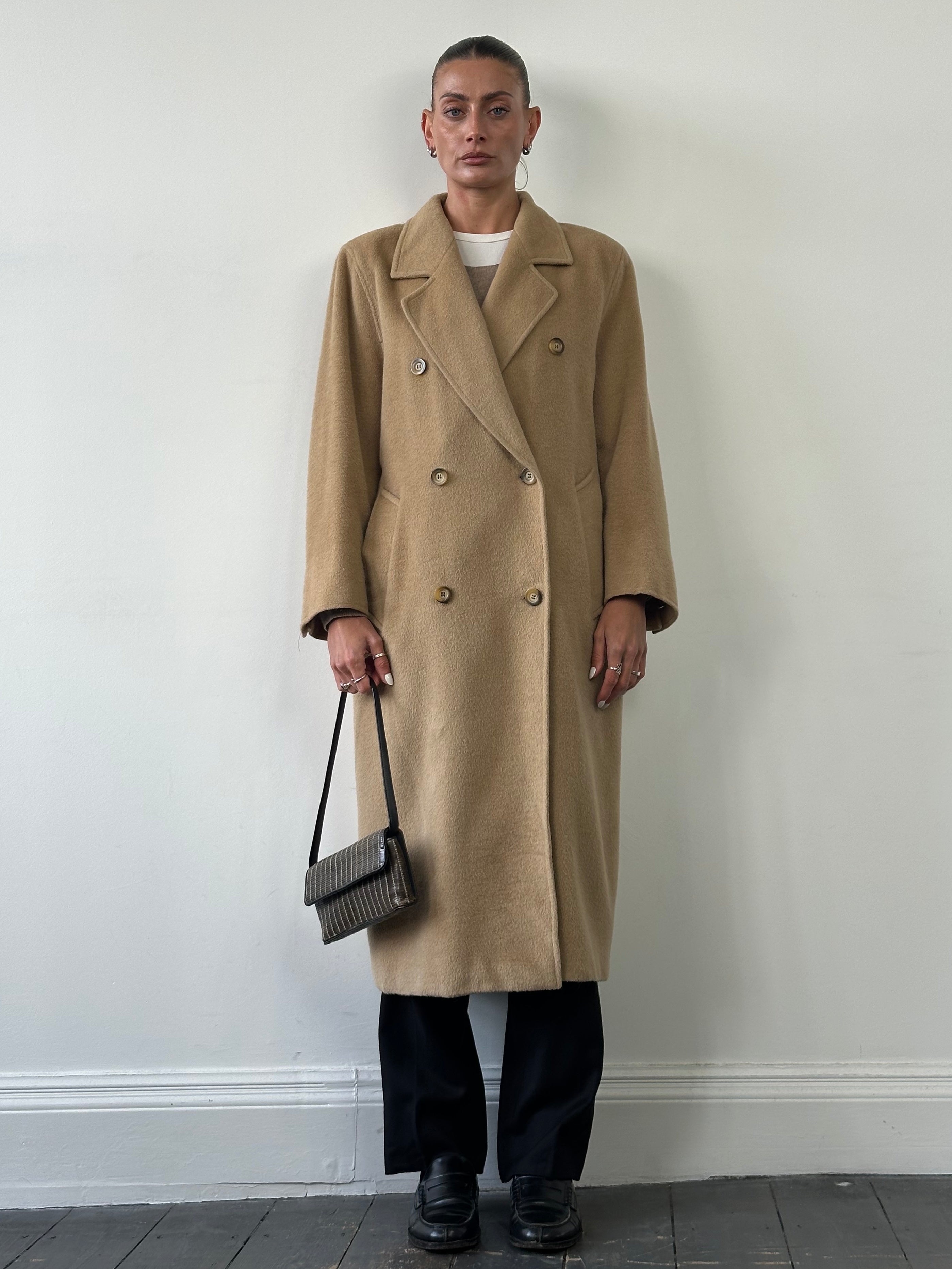 Max Mara wool camel hair double-breasted coat in size M/L displayed on a model, showcasing classic tailored style and warm fabric.