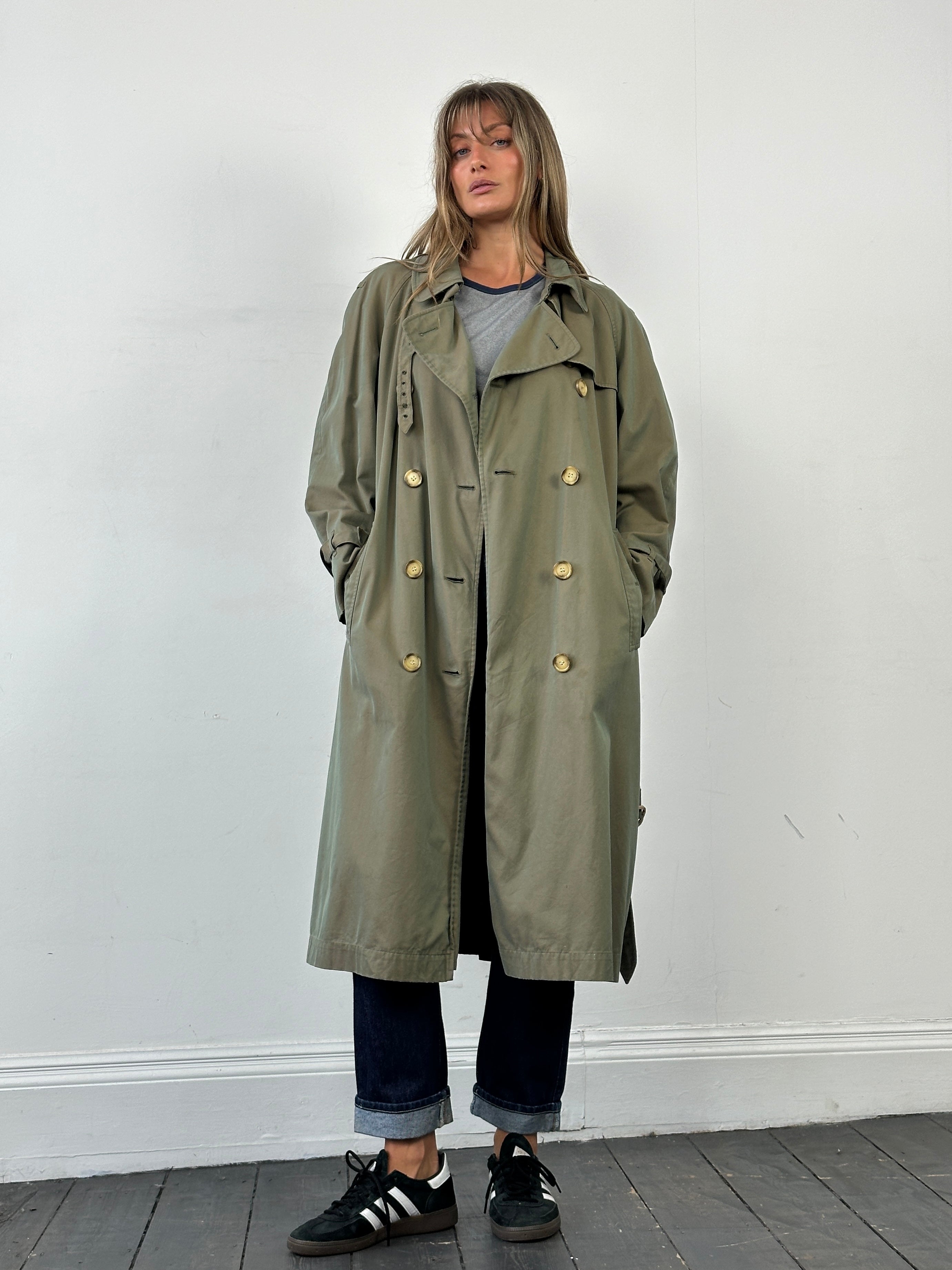Yves Saint Laurent 1980s Rive Gauche double-breasted trench coat in beige, classic design with wide lapels and belted waist.