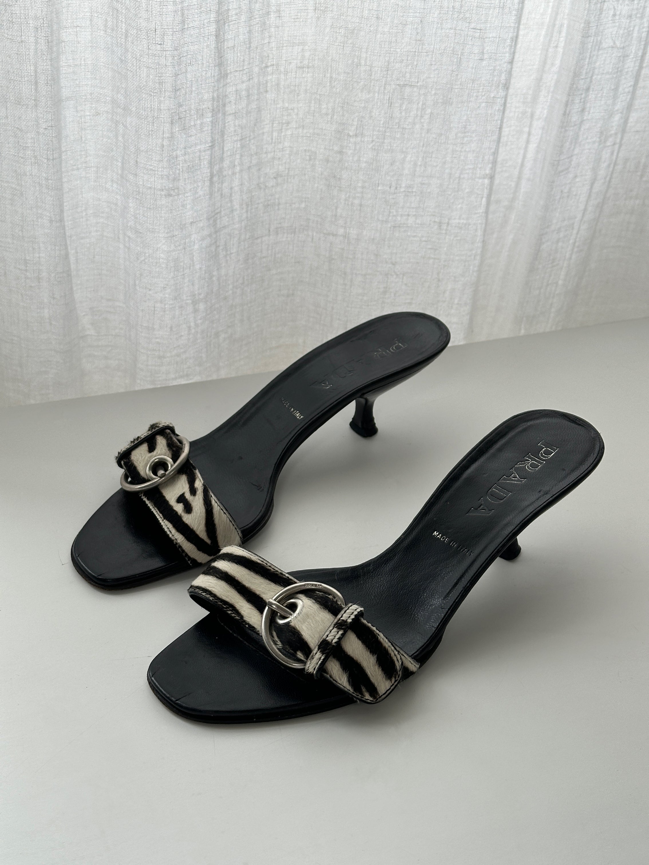 Prada zebra print pony hair kitten heels in UK 4.5 with pointed toe and sleek design, shown from side view.