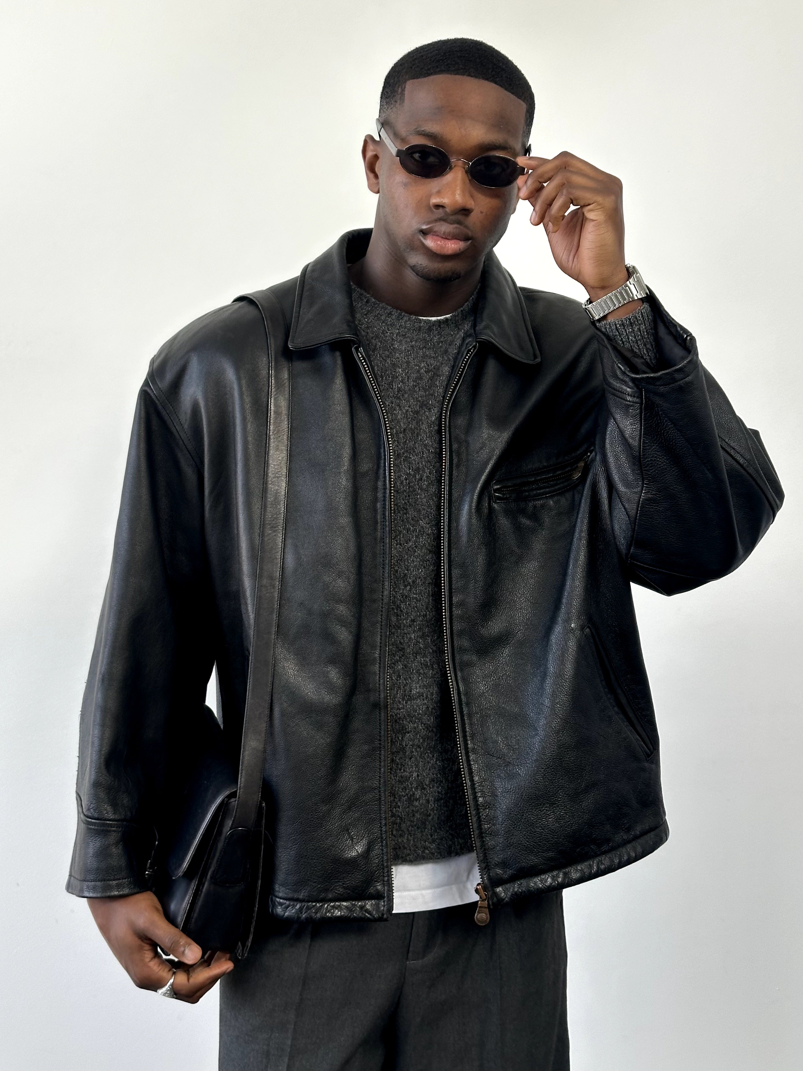 Vintage 1990s heavyweight leather jacket in XXL, minimal design, black leather with classic collar and front zipper.
