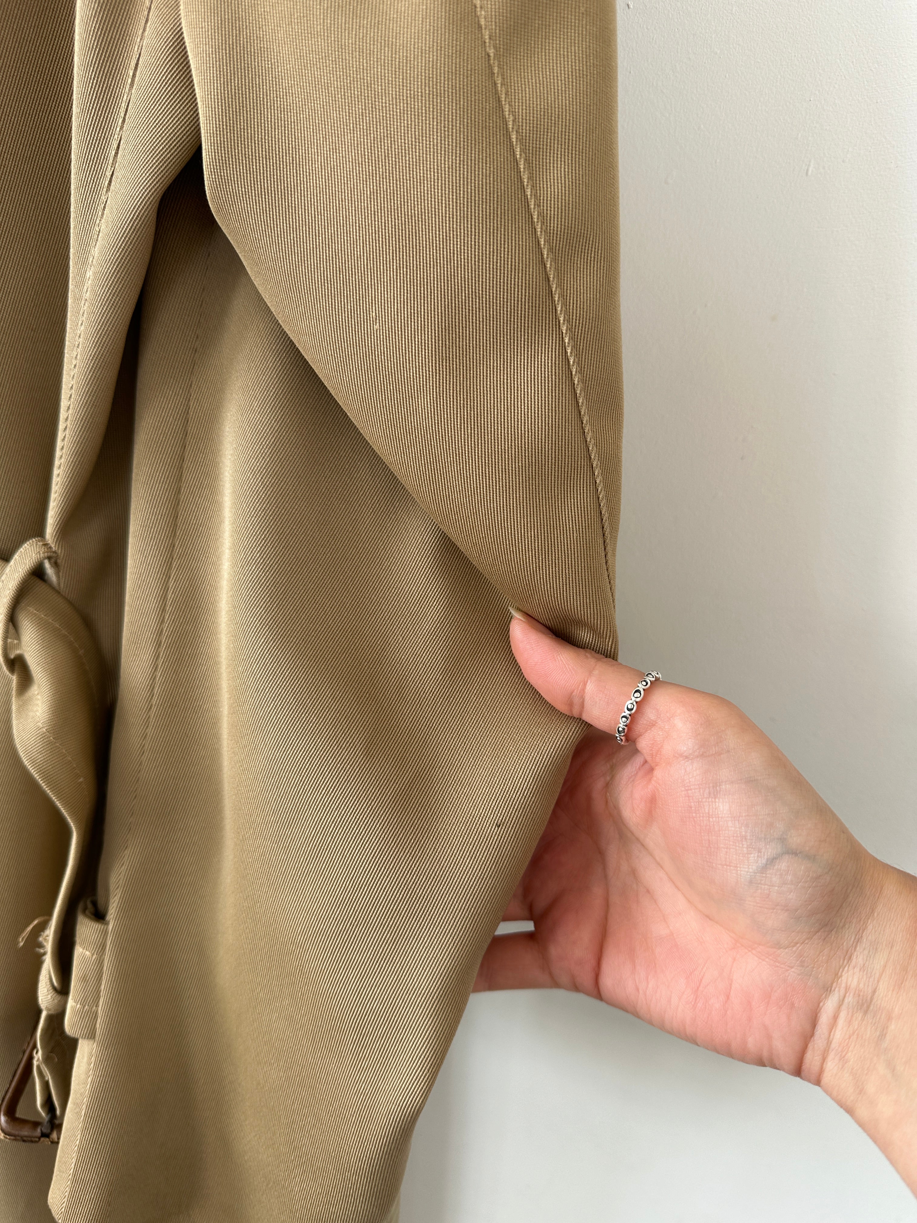 Vintage wool double-breasted trench coat in size L, featuring classic design and tailored fit, displayed on a neutral background.