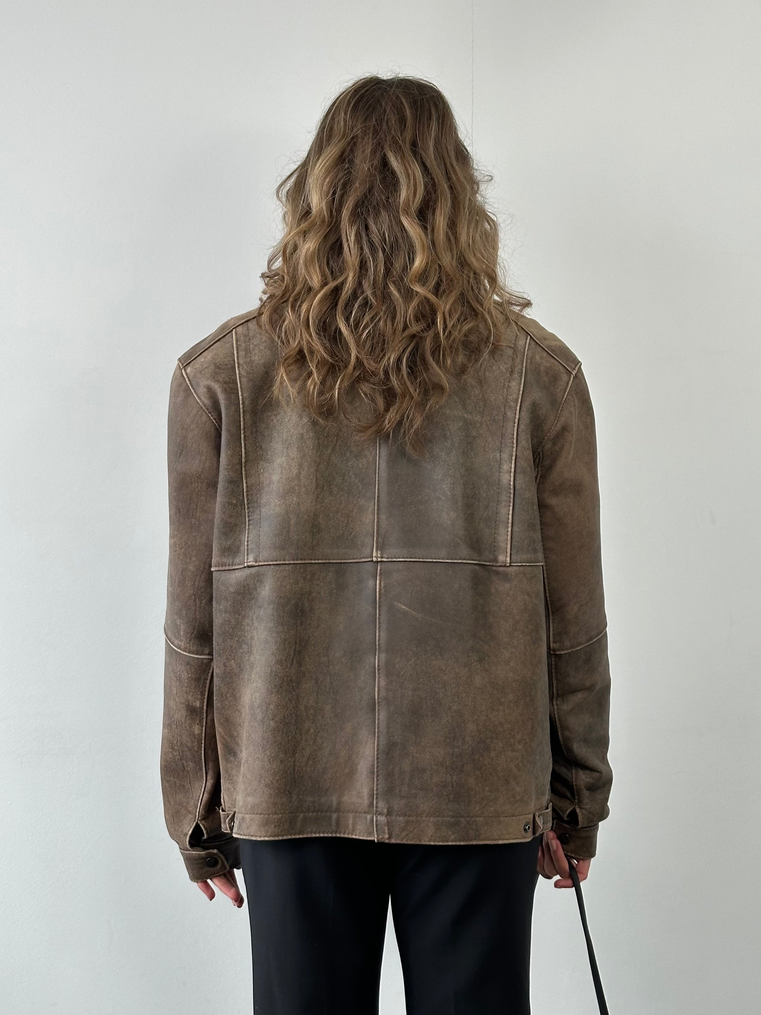 Vintage British vintage aged leather biker jacket in size M/L, featuring rugged leather with classic biker style and distressed finish.