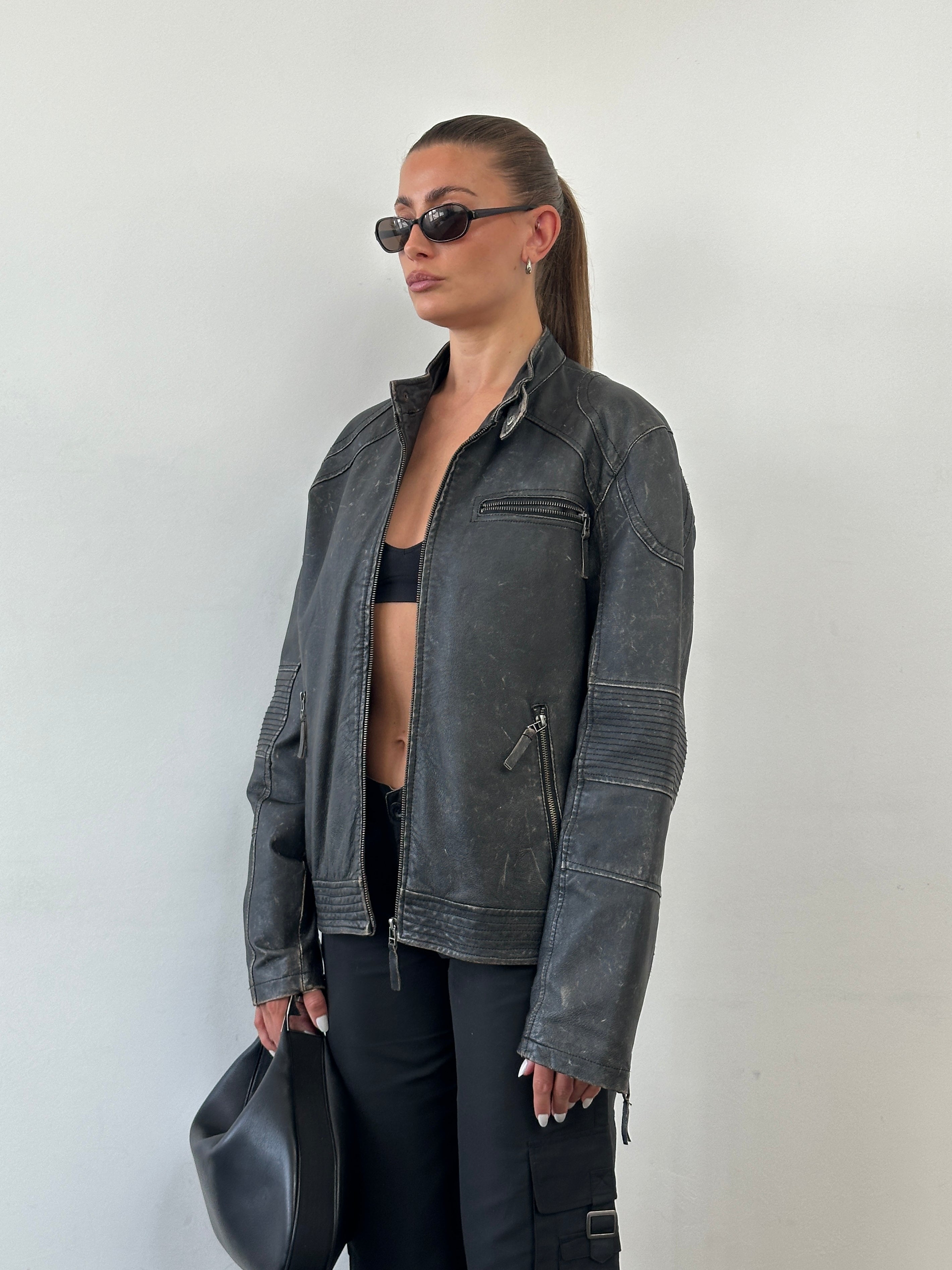 Vintage distressed leather moto jacket in size M/L, featuring rugged style and classic motorcycle-inspired design.