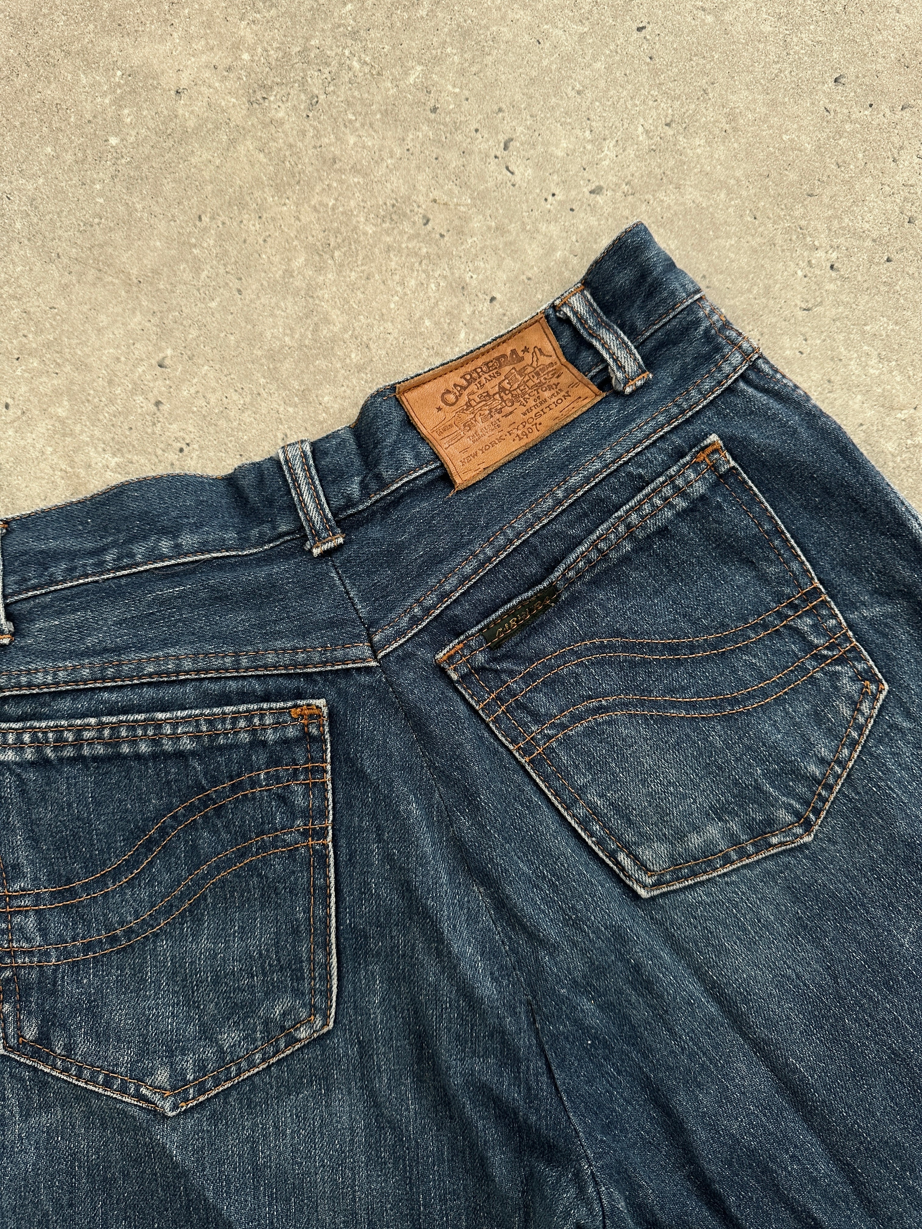 Carrera Italian straight leg denim jeans in size W30, showcasing classic blue denim with front pockets and belt loops.