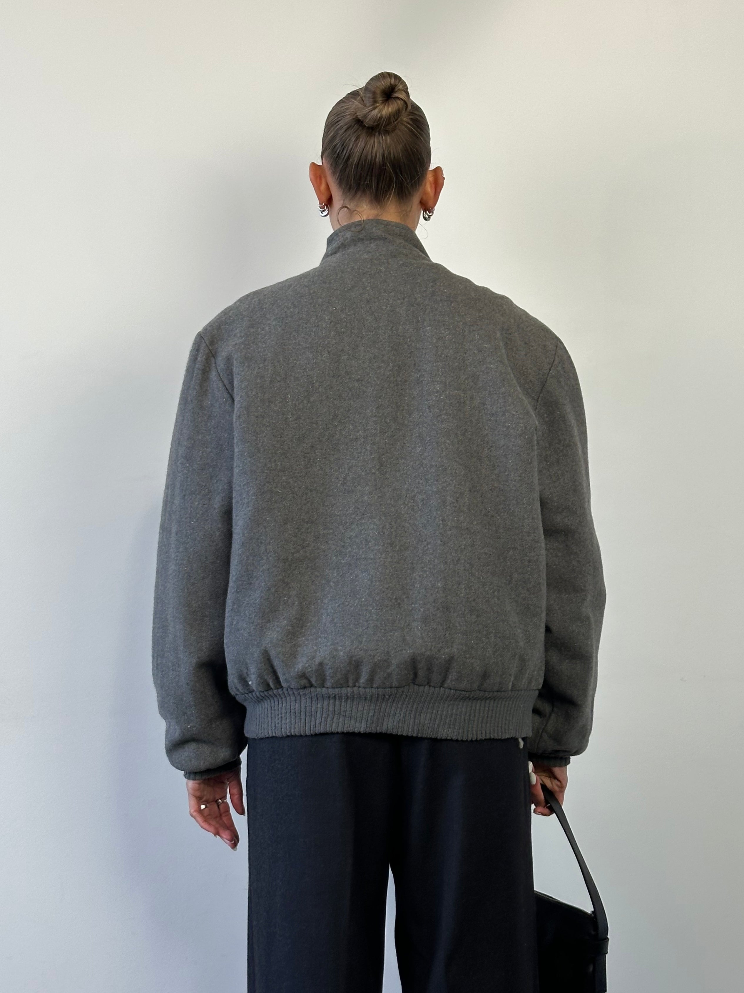 Vintage wool fleece-lined bomber jacket, size large, featuring a classic design with a warm interior and durable fabric.