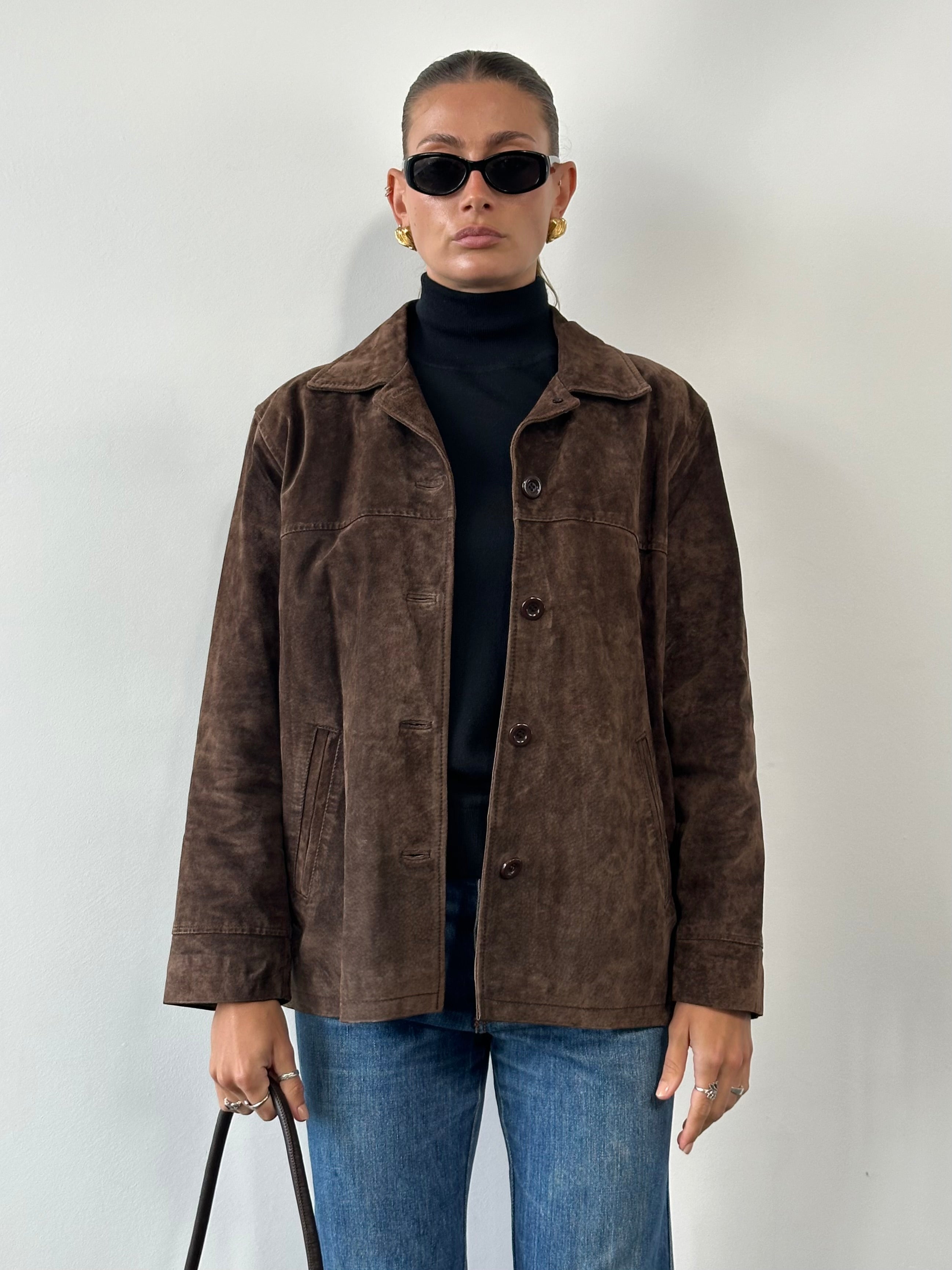 Vintage leather suede jacket in size large, featuring classic design and textured suede material, displayed on a neutral background.