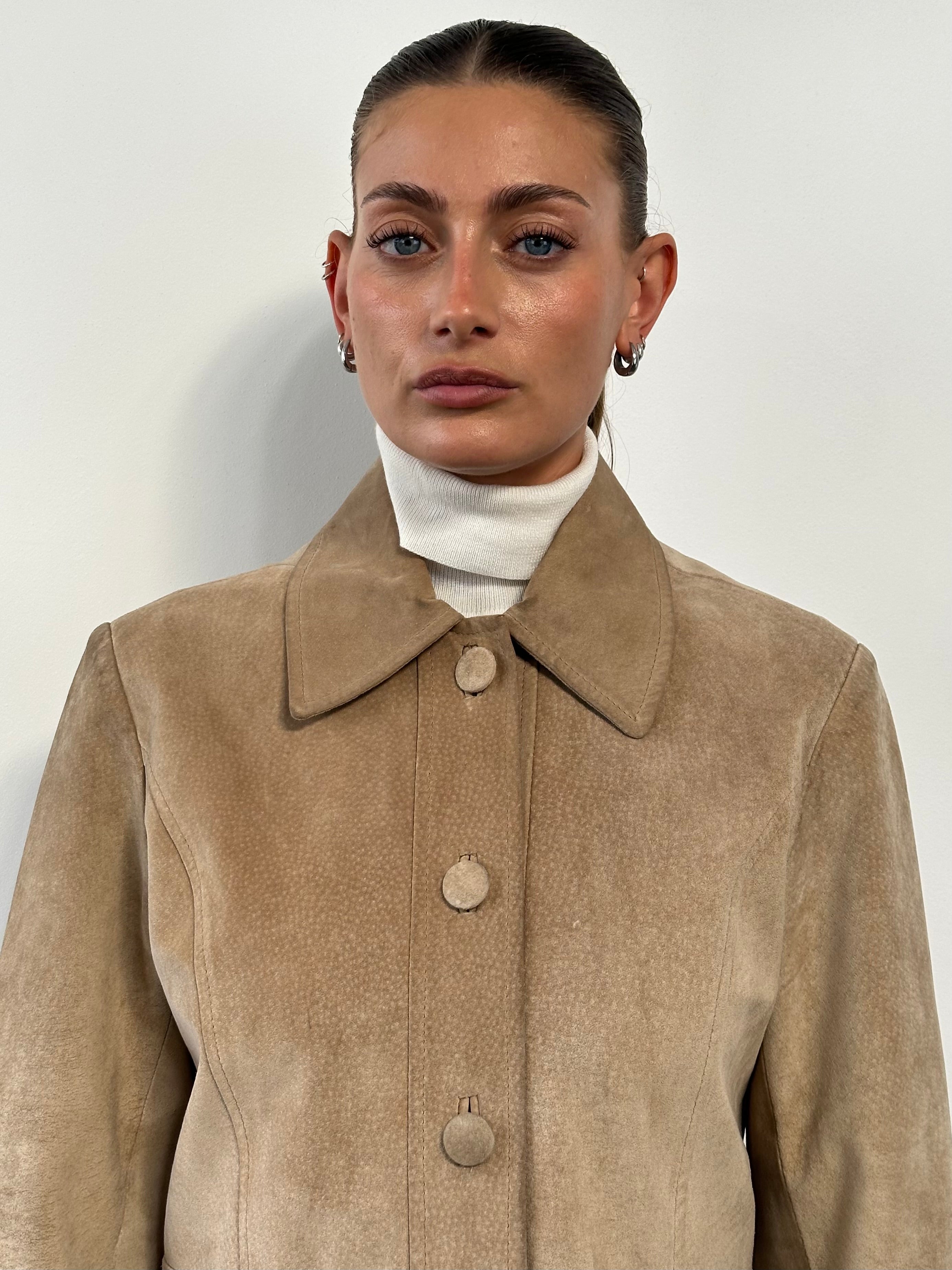 Vintage suede jacket in size M/L displayed on a hanger, showcasing its classic design and soft, textured material.