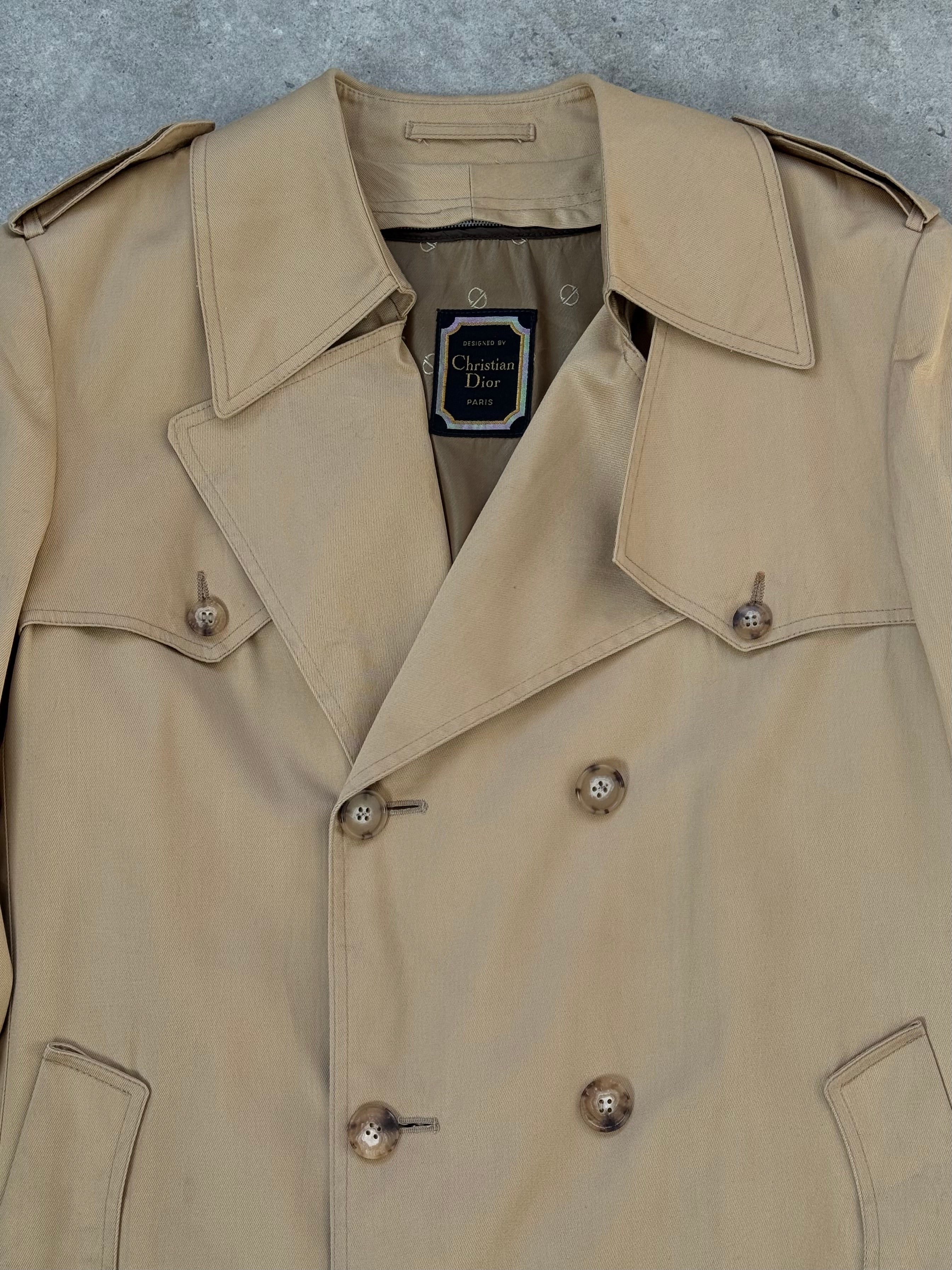 Christian Dior Paris 1980s cotton double-breasted trench coat in size L, shown hanging with classic collar and button details.
