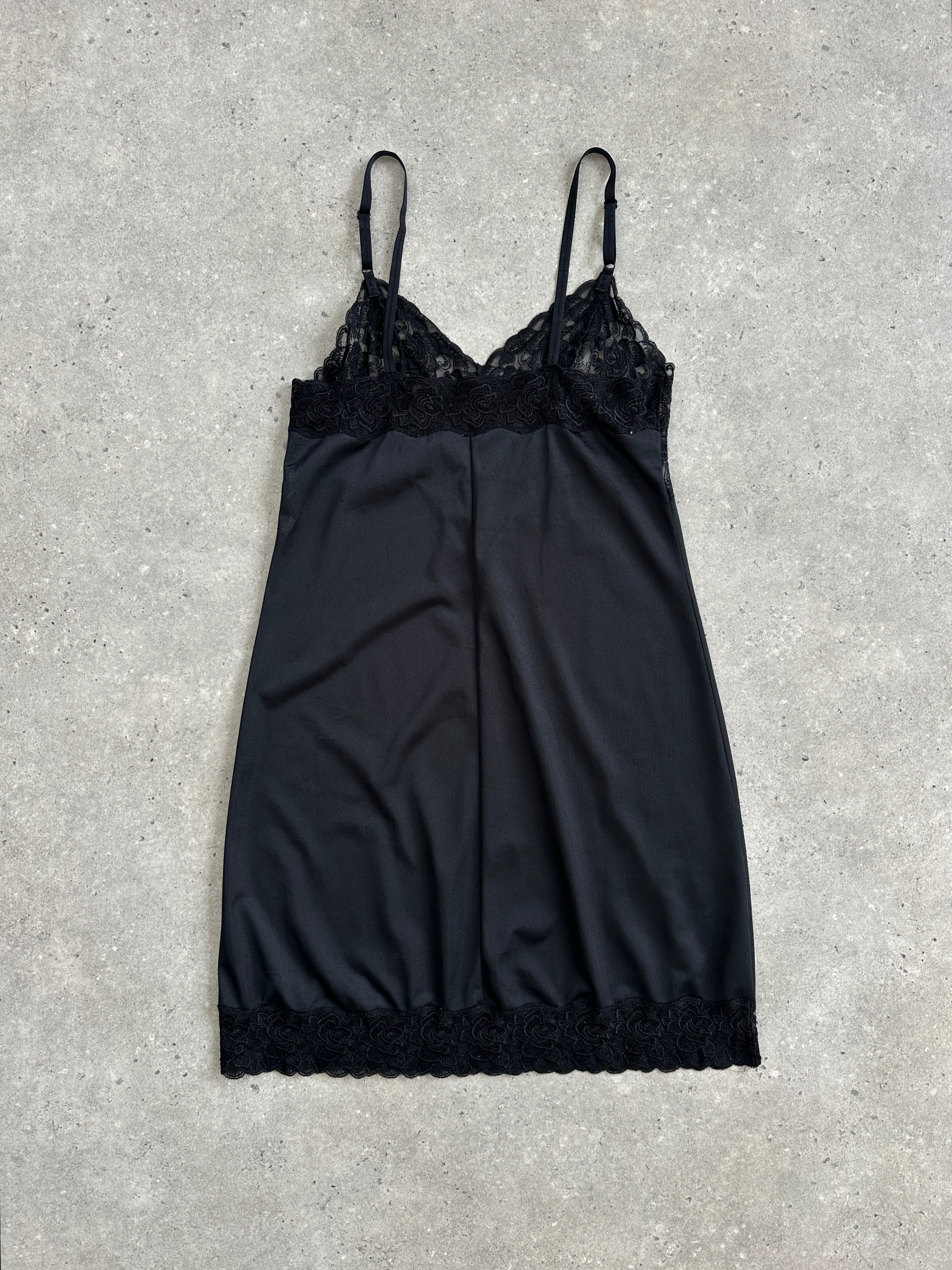 Vintage 1990s lace mini slip dress in black, featuring delicate lace details and a classic silhouette, size S/M.